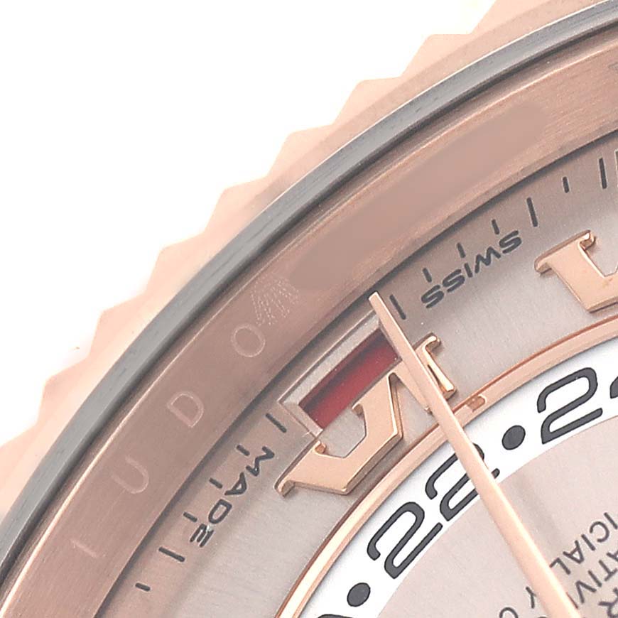 The image shows a close-up of the Rolex Sky-Dweller 326935 Men's Rose Gold Pink Dial's bezel and part of the dial with an arrow pointing to the date indicator.