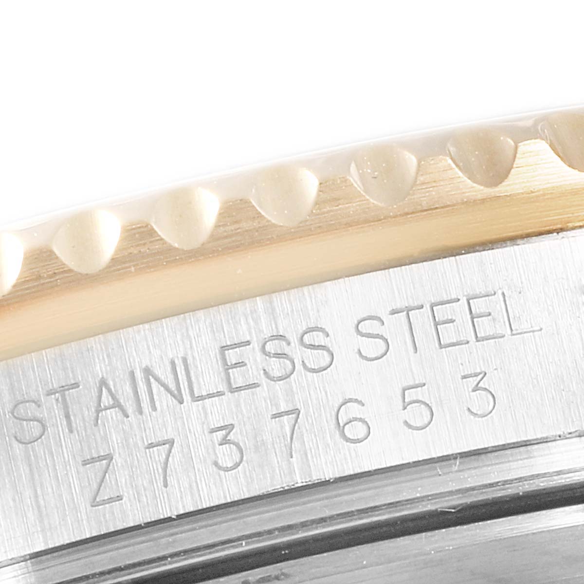 The image shows a close-up of the bezel and serial number engraving on a Rolex Submariner 16613 Men
s Steel and Gold (two tone) Blue Dial 16613 Men
s Steel and Gold (two tone) Blue Dial watch.