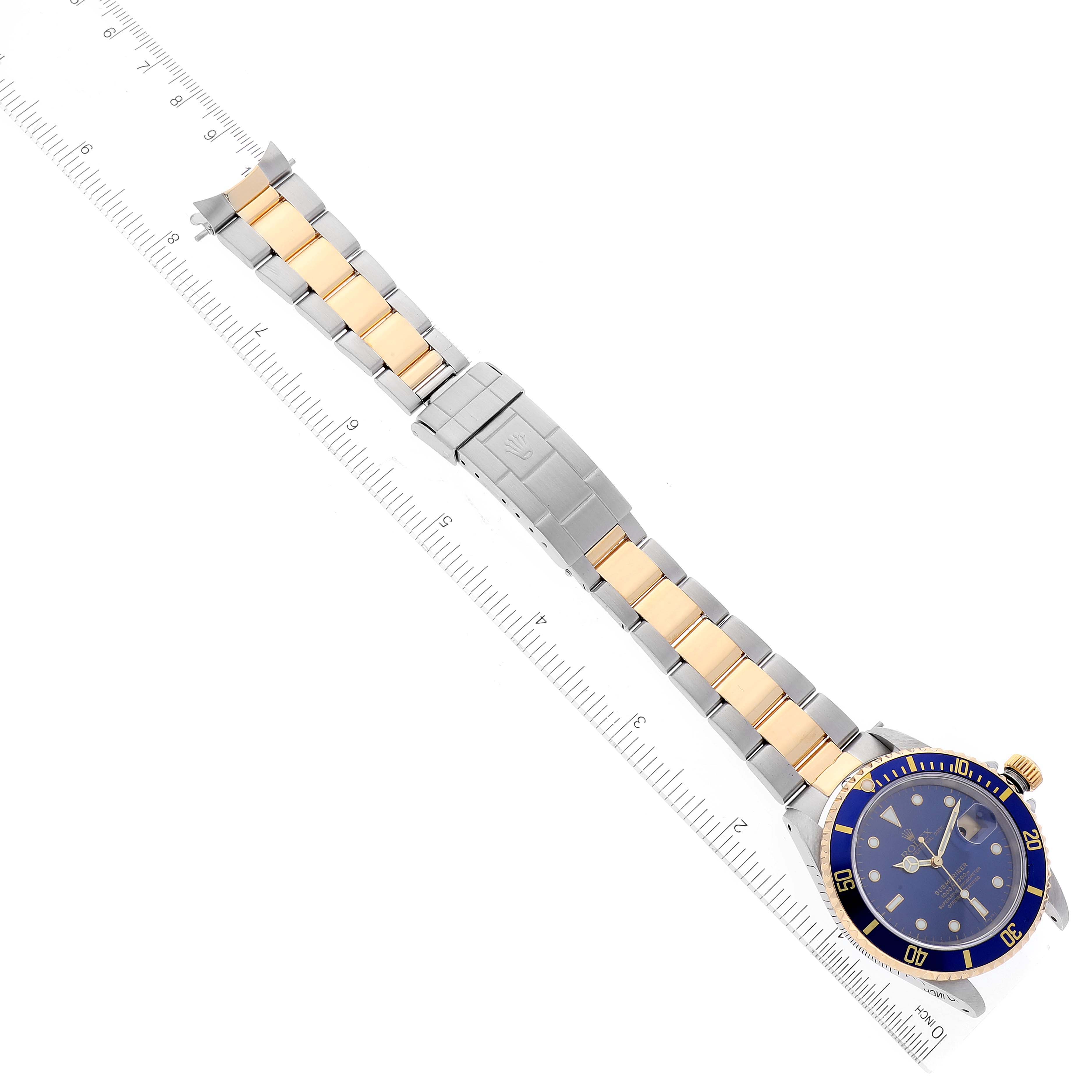 The image shows a top-down view of a Rolex Submariner 16613 Men
s Steel and Gold (two tone) Blue Dial 16613 Men
s Steel and Gold (two tone) Blue Dial watch, featuring its blue dial, two-tone bracelet, and deployment clasp.