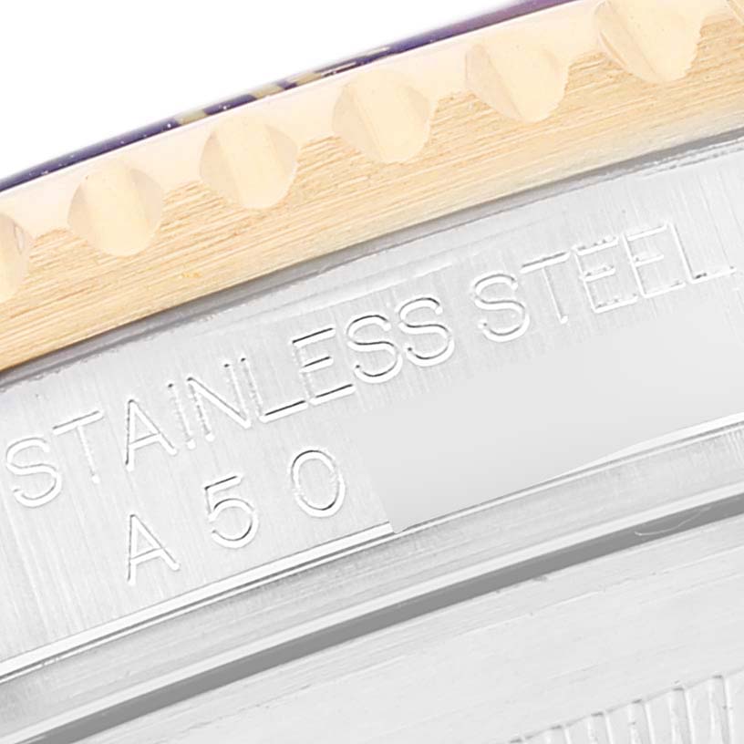 The image shows a close-up of the engraved side of the bezel and case of a Rolex Submariner 16613 Men
s Steel and Gold (two tone) Blue Dial 16613 Men
s Steel and Gold (two tone) Blue Dial watch.