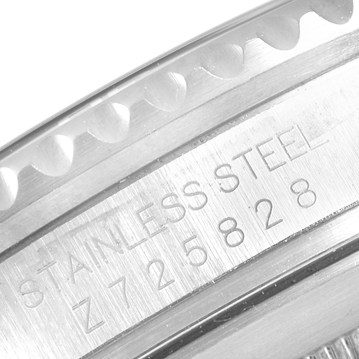 The image shows a close-up of the stainless steel case and engraved serial number on a Rolex Submariner 16610 Men's Stainless Steel Black Dial 16610 Men's Stainless Steel Black Dial watch.