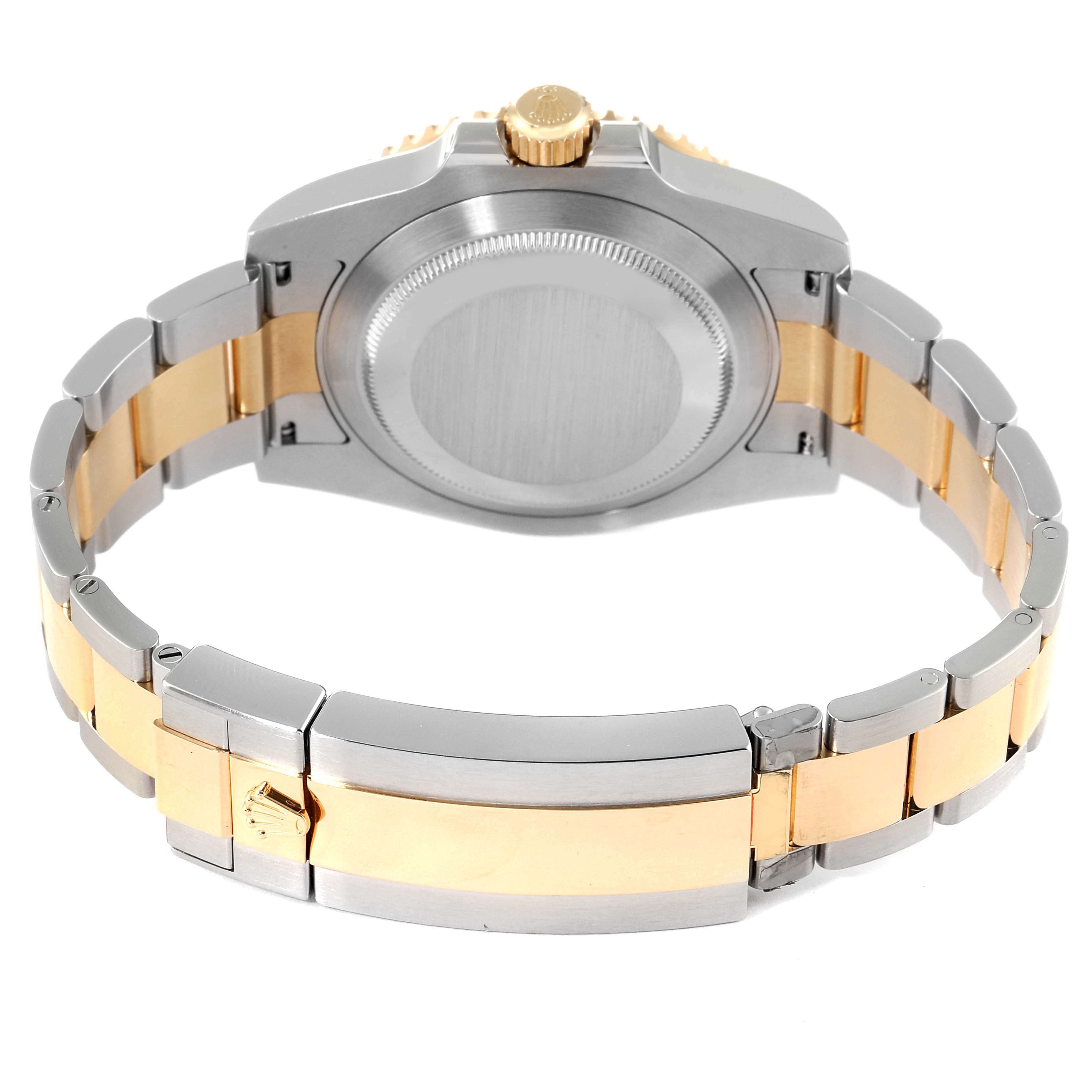 The image shows the back view of a Rolex Submariner 116613 Men
s Steel and Gold (two tone) Blue Dial 116613 Men
s Steel and Gold (two tone) Blue Dial watch, highlighting its two-tone bracelet and case back.