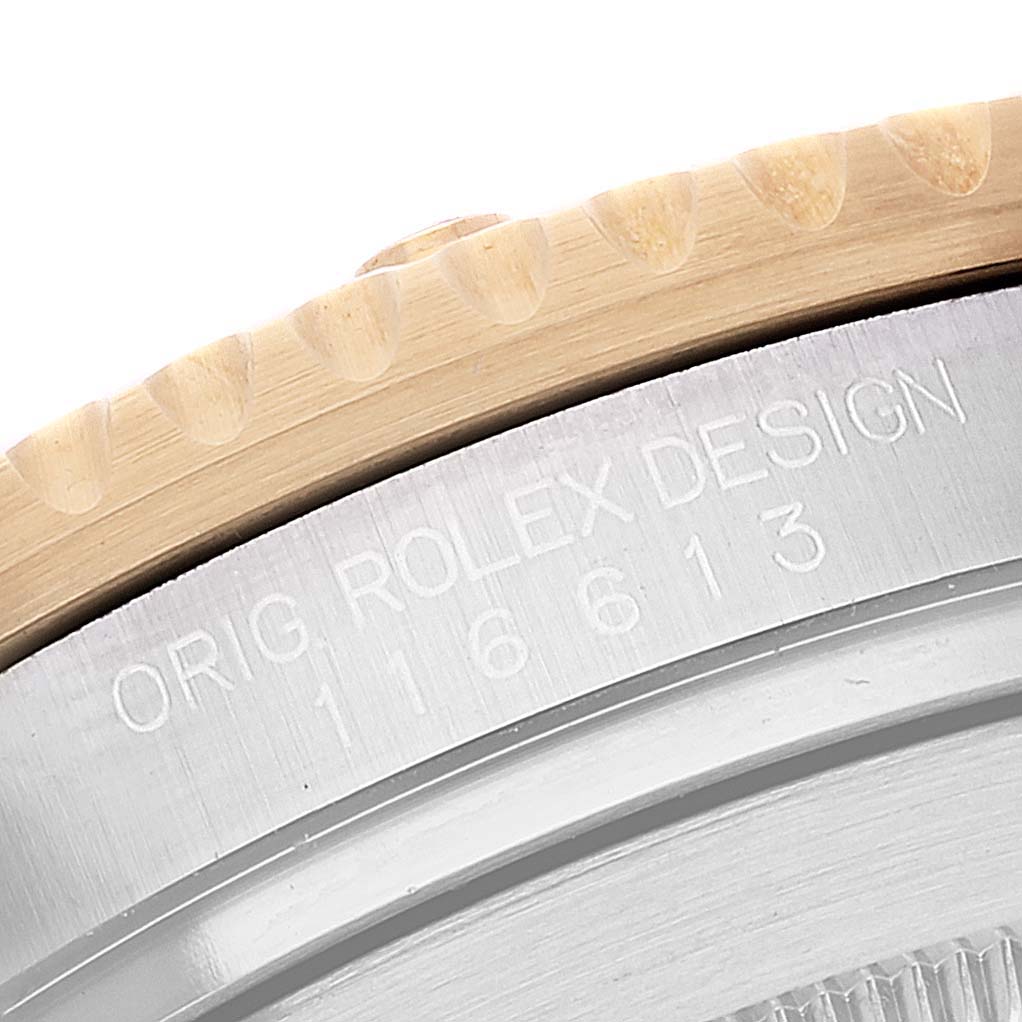 The image shows a close-up of the side of a Rolex Submariner 116613 Men
s Steel and Gold (two tone) Blue Dial 116613 Men
s Steel and Gold (two tone) Blue Dial watch, highlighting the bezel and engraved model number 16613.