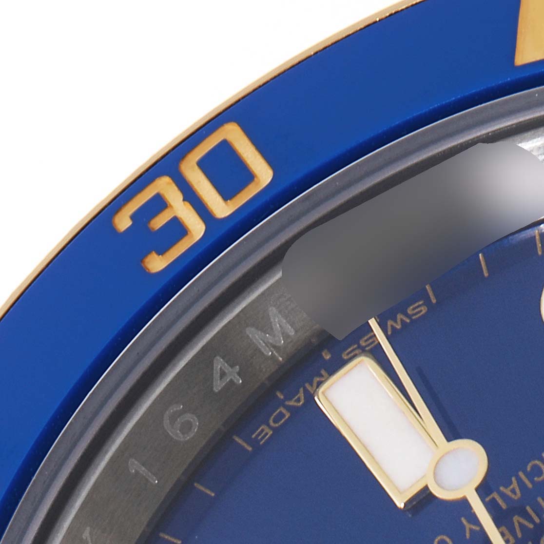 The image shows a close-up of the bezel, dial, and part of the minute hand of a Rolex Submariner 116613 Men
s Steel and Gold (two tone) Blue Dial 116613 Men
s Steel and Gold (two tone) Blue Dial watch.