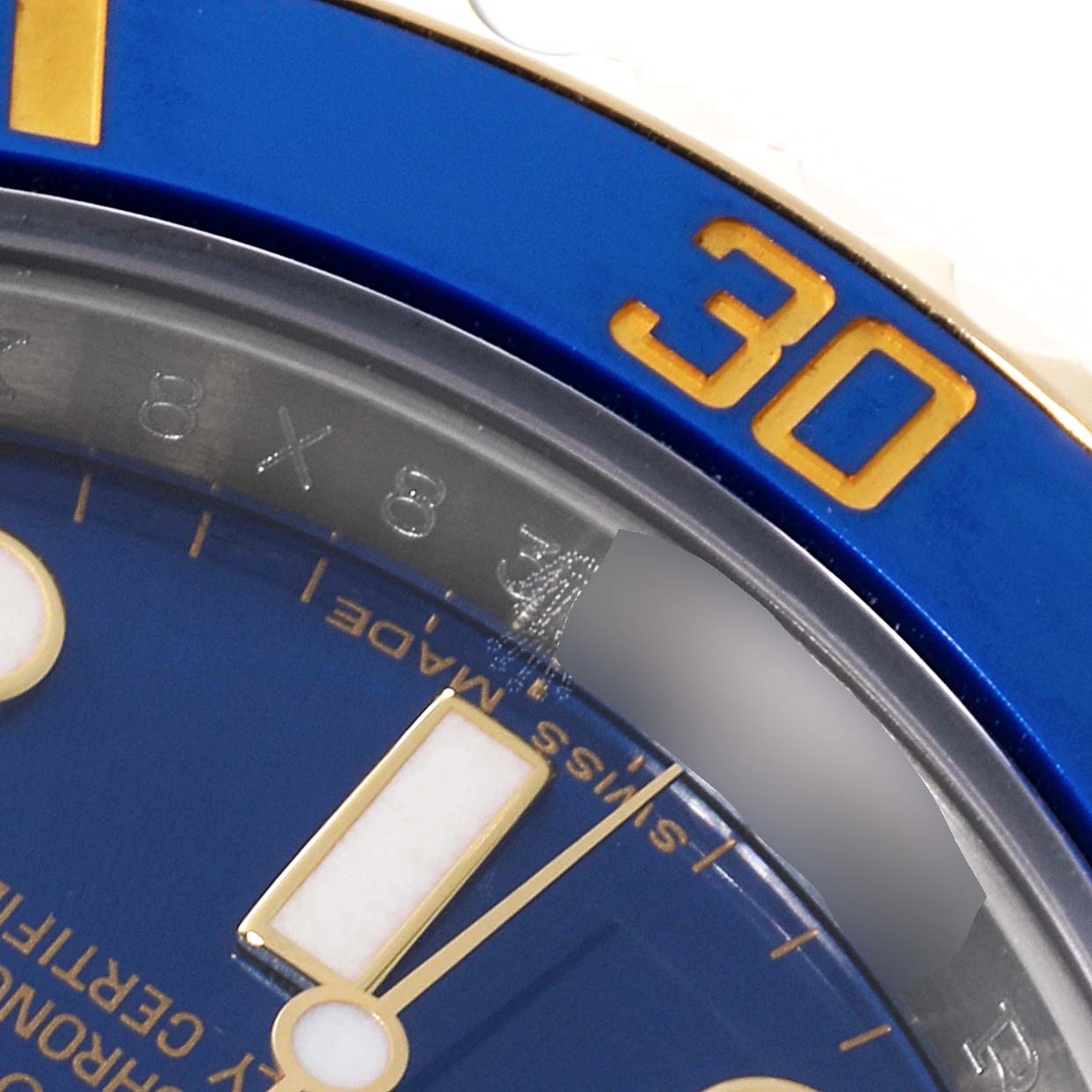 The image shows a close-up of the dial and bezel, specifically the 30-minute marker, of a Rolex Submariner 116613 Men
s Steel and Gold (two tone) Blue Dial 116613 Men
s Steel and Gold (two tone) Blue Dial watch.