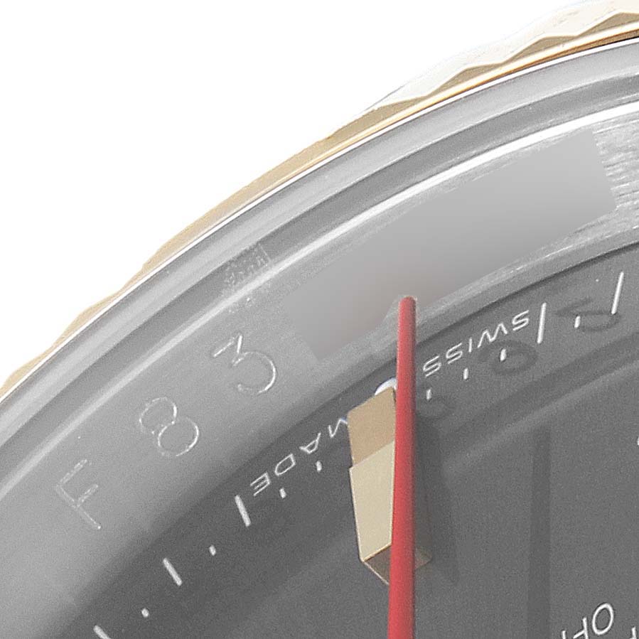 The image shows a close-up of the bezel, partial dial, and red second hand of the Rolex Turn-o-Graph 116263 Men's Steel and Gold (two tone) Grey Dial 116263 Men's Steel and Gold (two tone) Grey Dial watch.