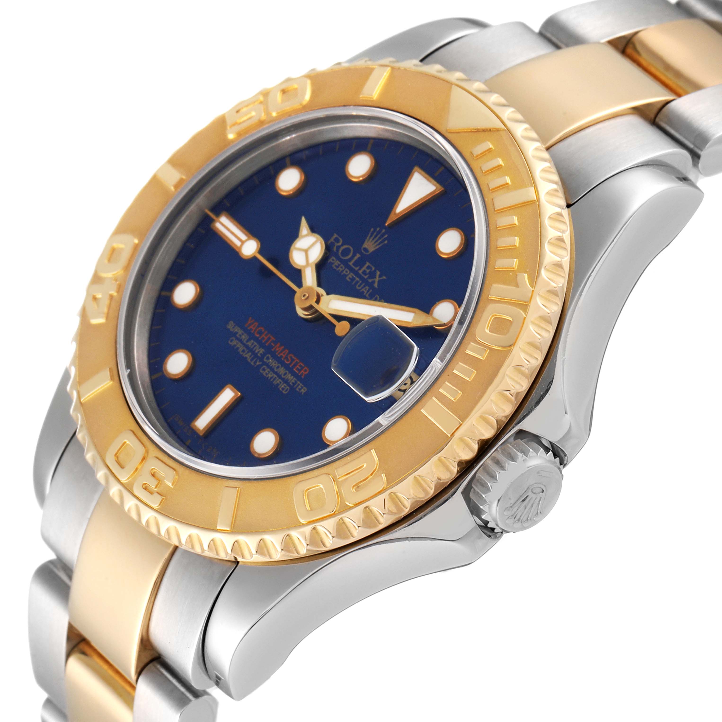 The Yacht-Master Rolex watch is shown from a slight angled side view, highlighting the blue dial, gold bezel, and part of the bracelet.