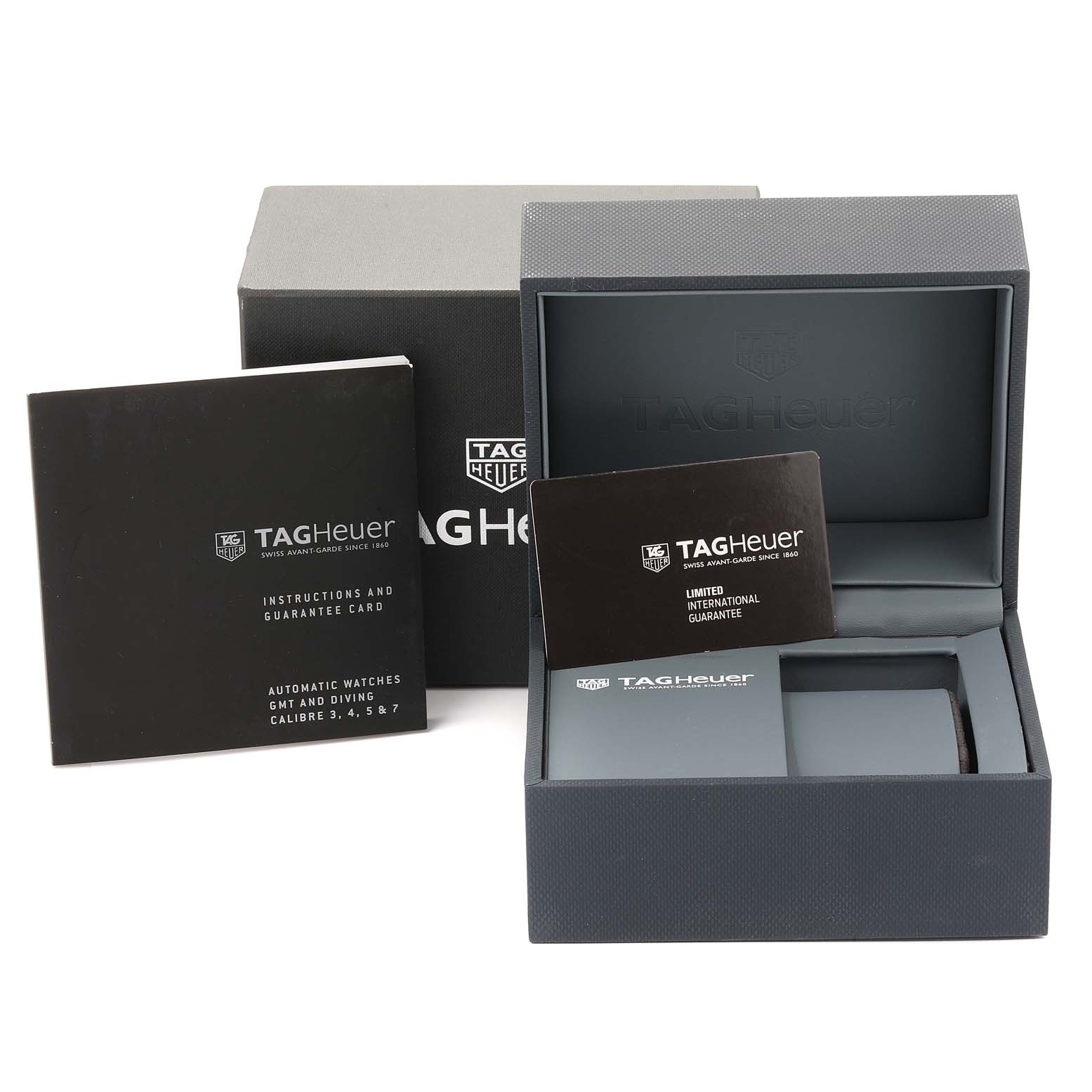 The image shows the box and papers, including an instruction manual and guarantee card, for a Tag Heuer Aquaracer WAJ2110.FT6015 Men's Stainless Steel Black Dial WAJ2110.FT6015 Men's Stainless Steel Black Dial watch.