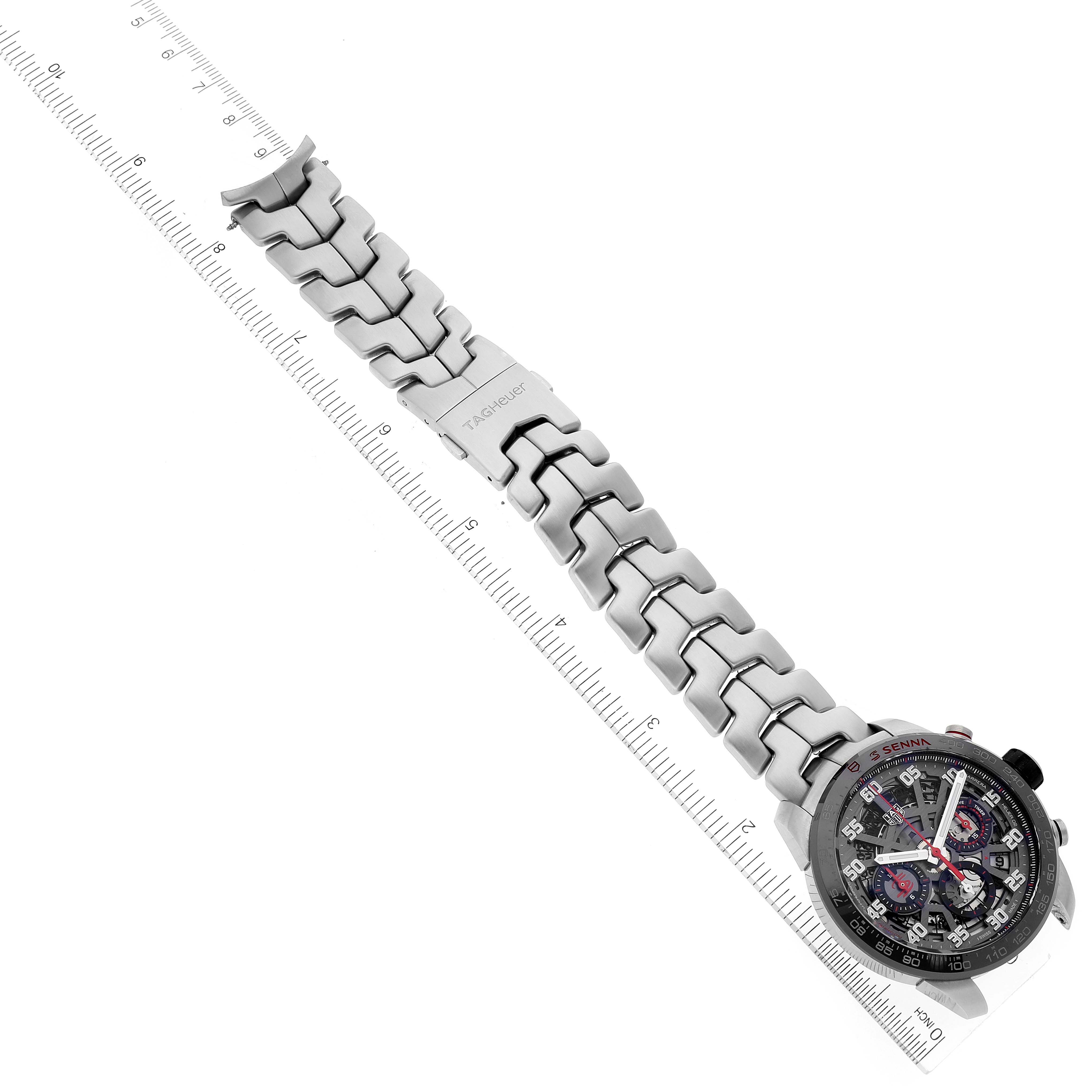 The Tag Heuer Carrera CBG2013 Men's Stainless Steel Transparent Dial CBG2013 Men's Stainless Steel Transparent Dial watch is shown at a top-down angle featuring the entire watch band and face adjacent to a ruler for scale.