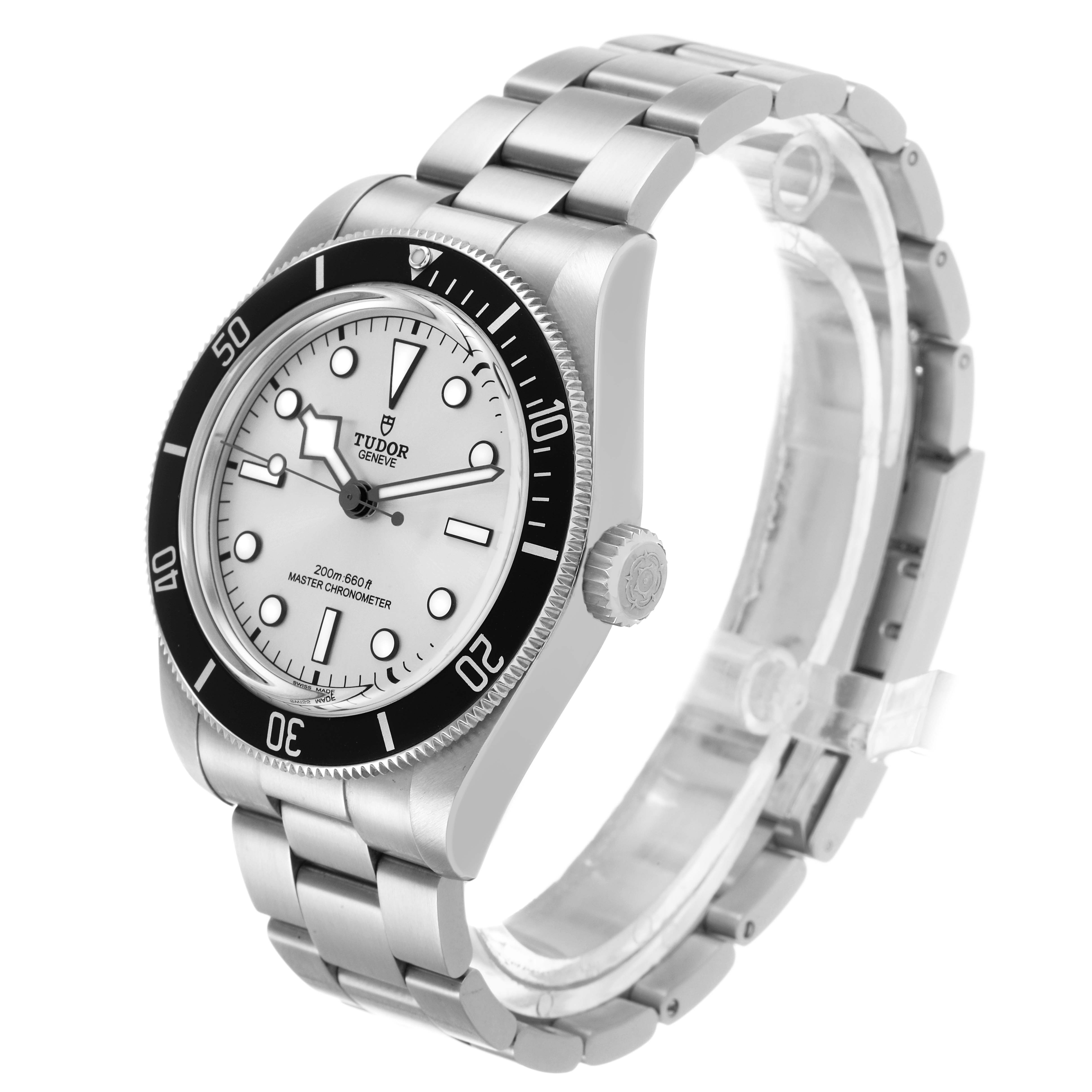 The Tudor Heritage Black Bay 7943A1A0NU Men's Stainless Steel Silver Dial watch is shown at a three-quarter angle, displaying its dial, bezel, crown, and bracelet.