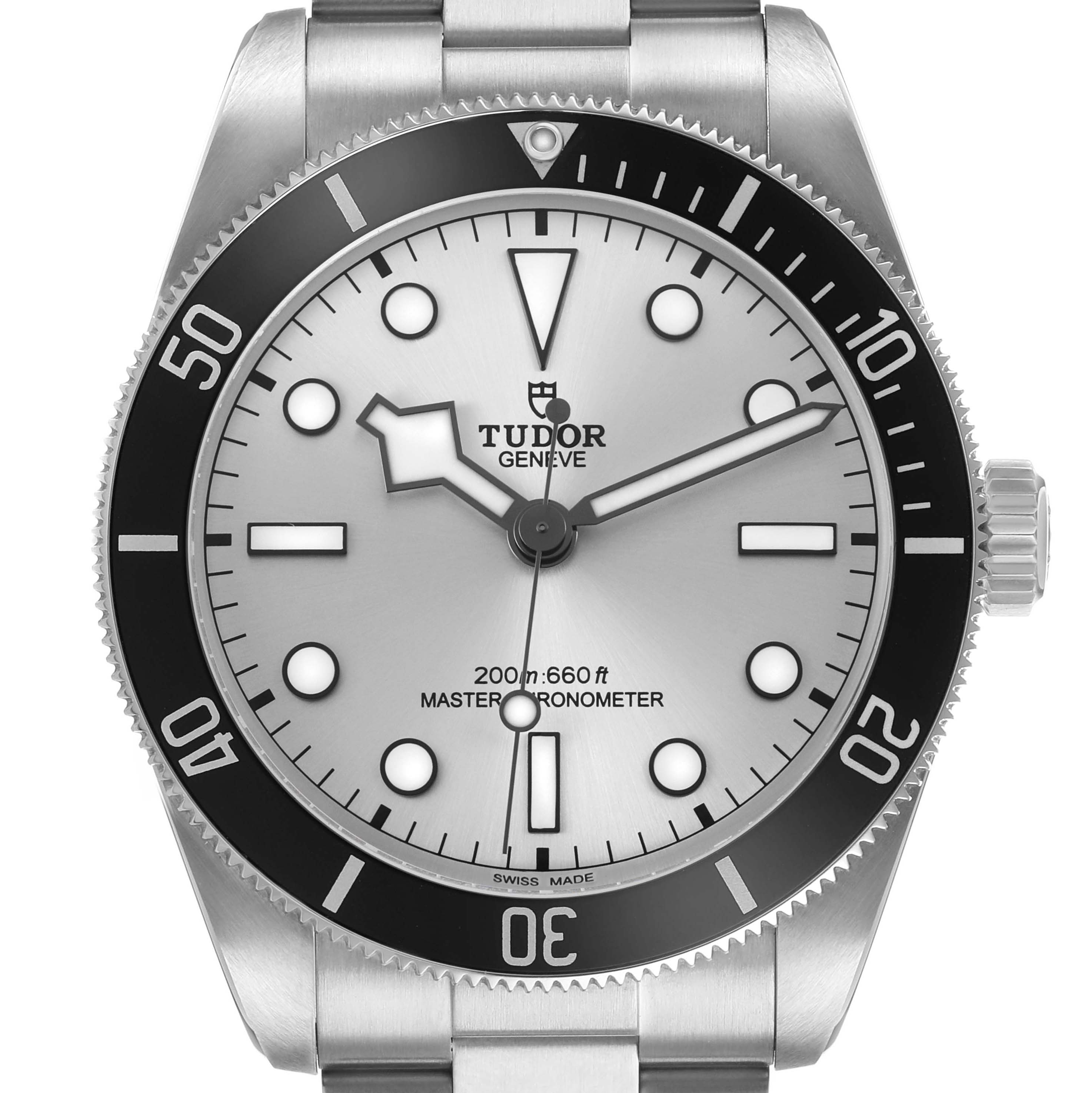 The Tudor Heritage Black Bay 7943A1A0NU Men's Stainless Steel Silver Dial watch is shown from a front angle, featuring its dial, bezel, and part of the bracelet.