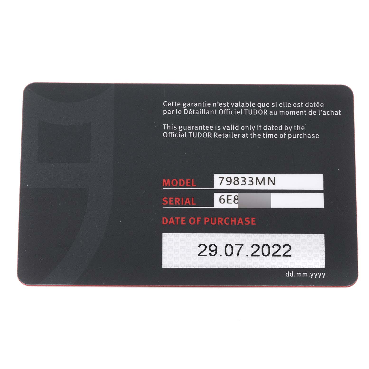 The image shows a warranty card for the Tudor Heritage Black Bay 79833MN Men's Steel and Gold (two tone) Black Dial 79833MN Men's Steel and Gold (two tone) Black Dial model. The card includes the model number, serial number, and purchase date.