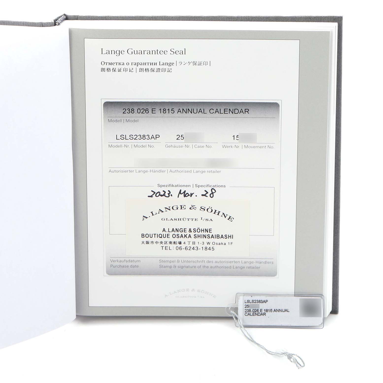 The image shows the warranty and Best Quality
ity booklet for an A. Lange 
Sohne 1815 238.026/LSLS2383AP Men
s White Gold Silver Dial model, with a tag attached.