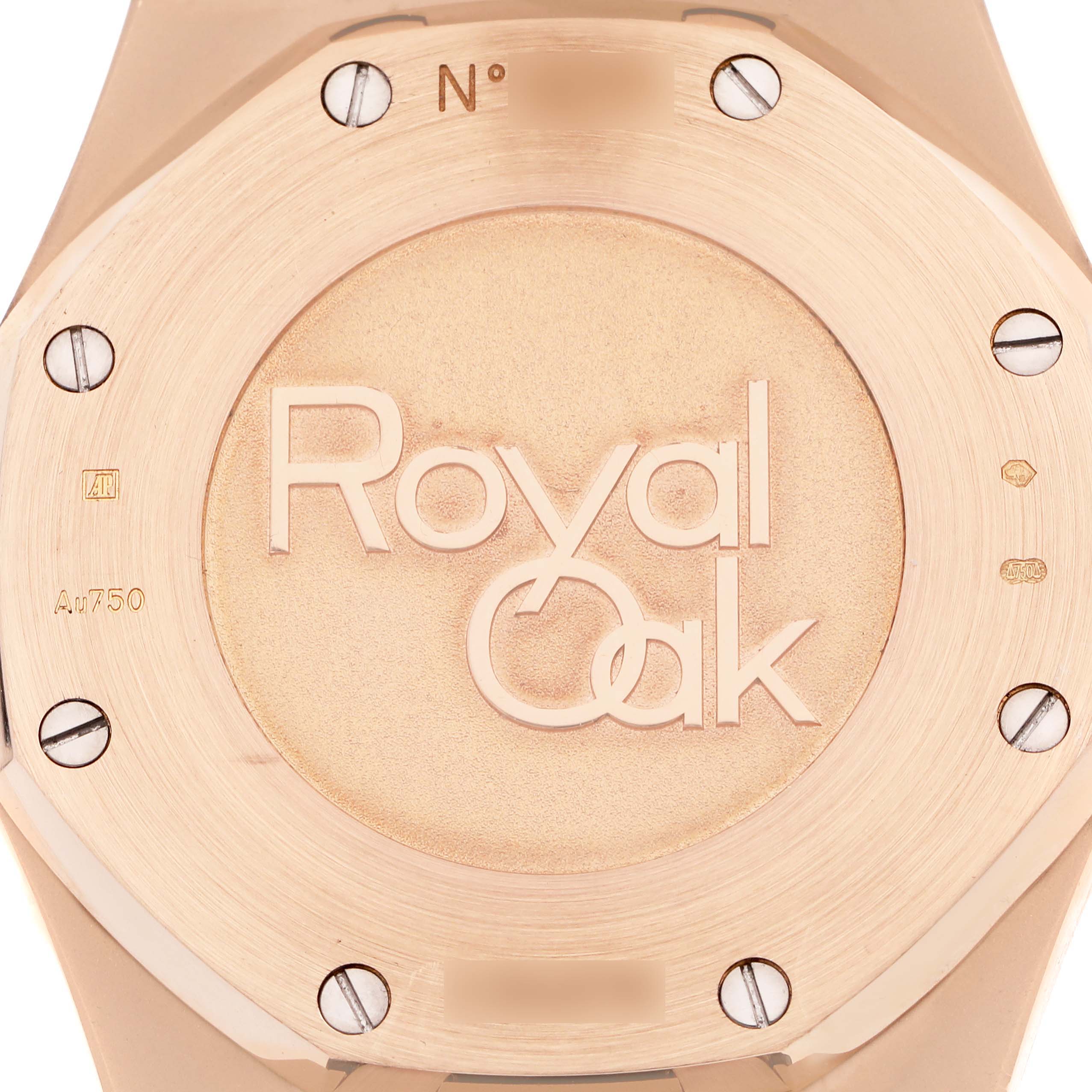 The image shows the back of an Audemars Piguet Royal Oak 26120OR.OO.D088CR.01 Men
s Rose Gold Silver Dial 26120OR.OO.D088CR.01 Men
s Rose Gold Silver Dial watch, highlighting the engraved logo and screws.