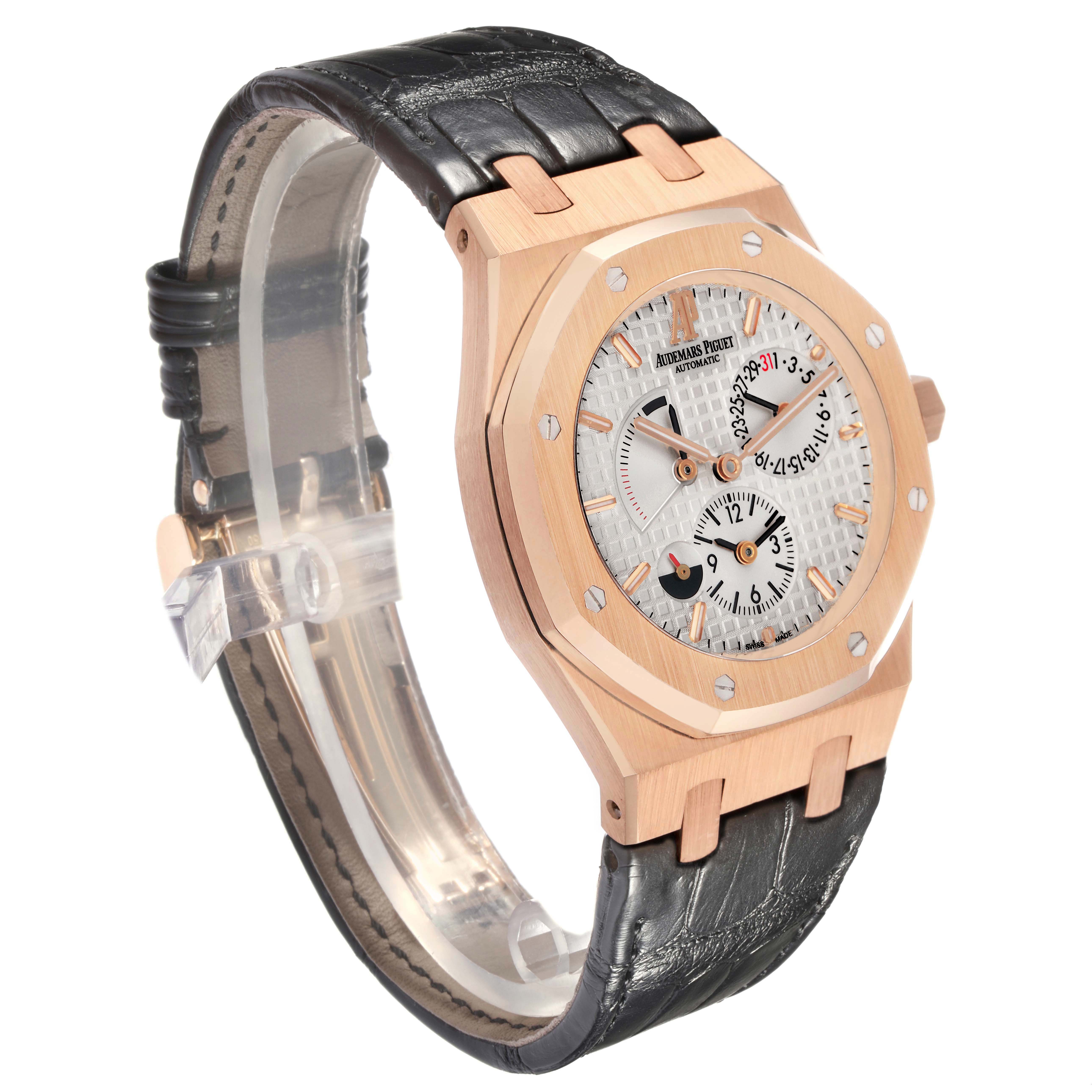The Audemars Piguet Royal Oak 26120OR.OO.D088CR.01 Men
s Rose Gold Silver Dial watch is shown at a three-quarter angle, highlighting the rose gold case, dial, and leather strap.