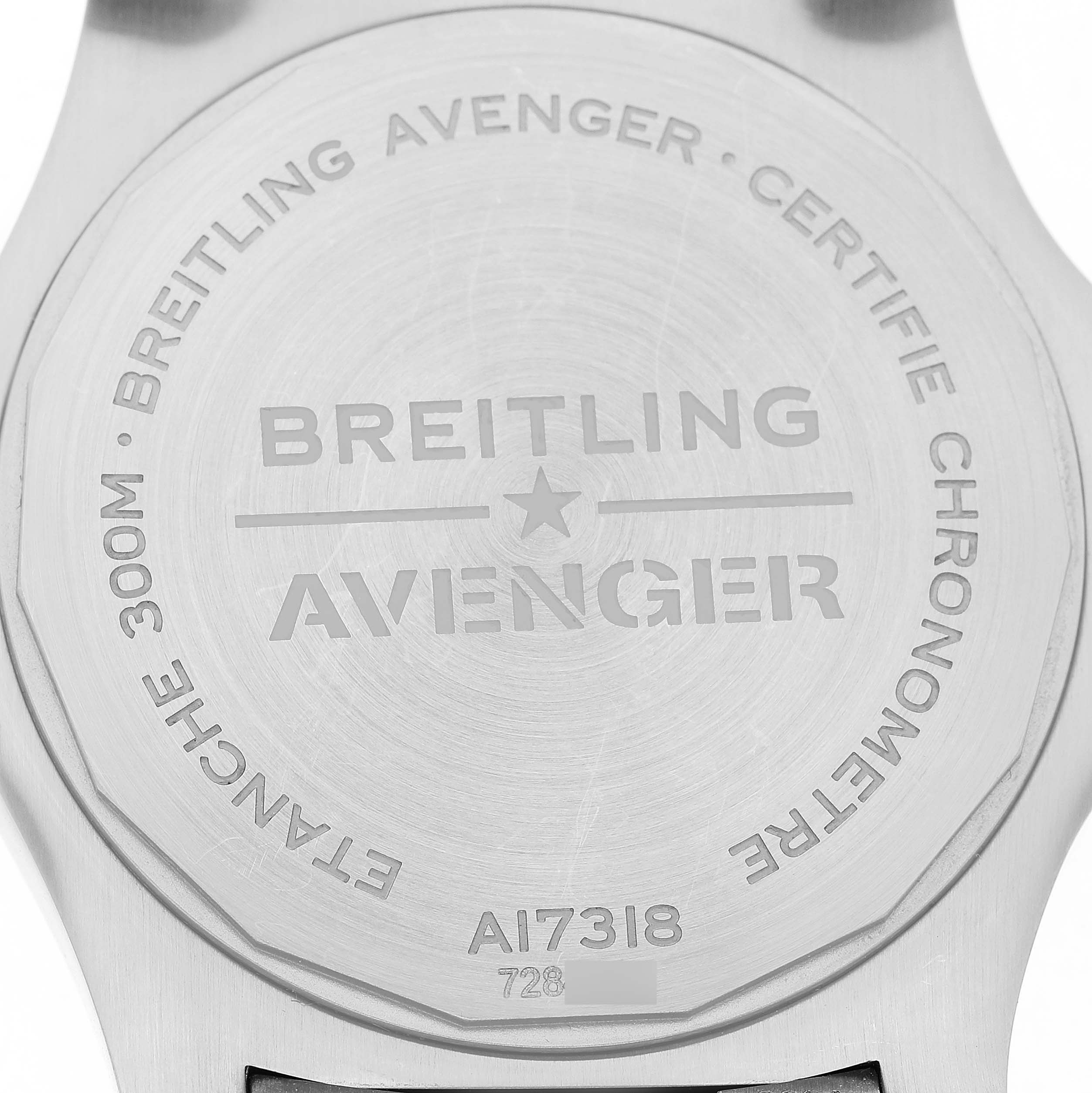The image shows the case back of the Breitling Avenger A17318 Men's Stainless Steel Black Dial watch, displaying engravings and specifications.