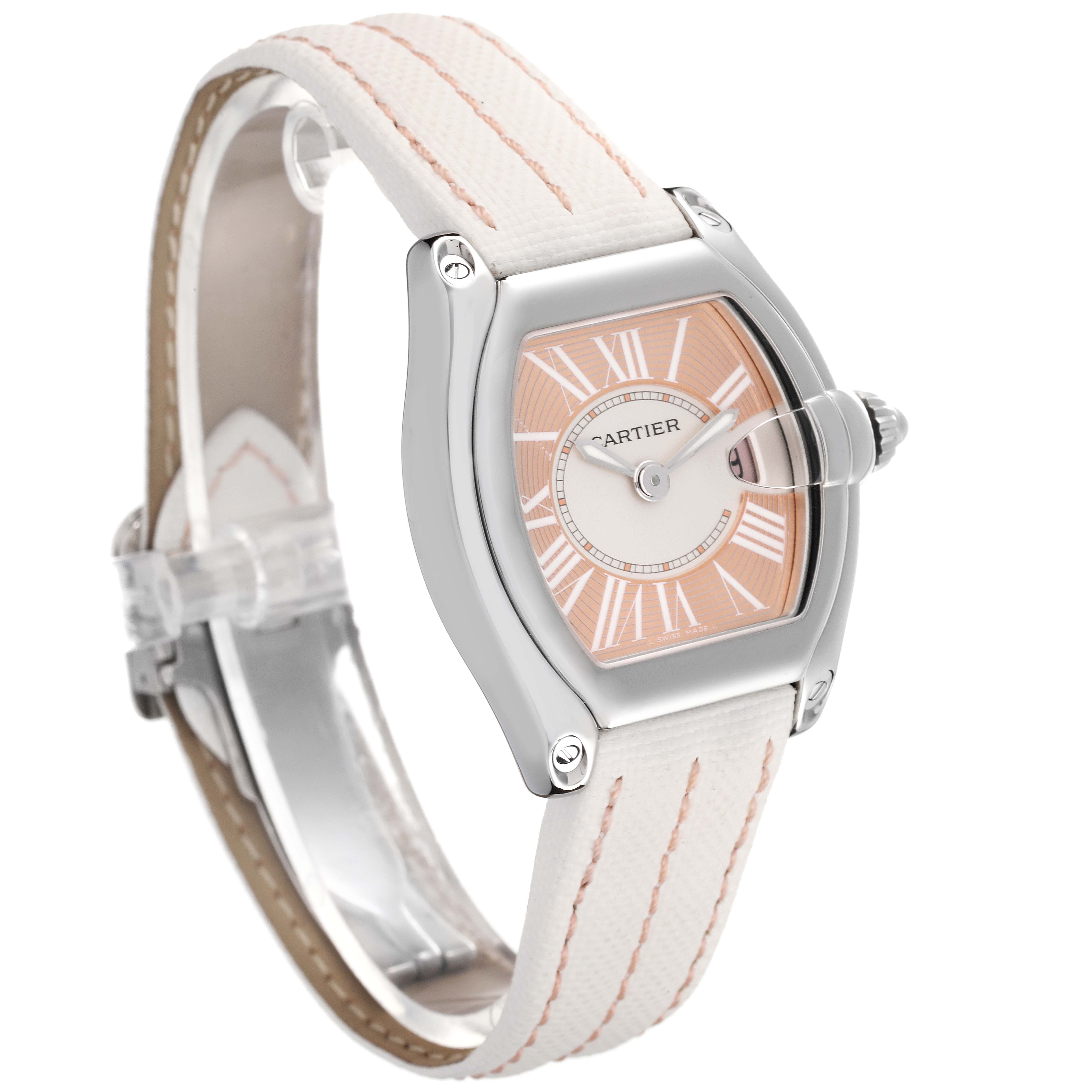 The Cartier Roadster W62054V3 Women
s Stainless Steel Pink Dial W62054V3 Women
s Stainless Steel Pink Dial watch is shown at a three-quarter angle, highlighting its face, bezel, and white strap.