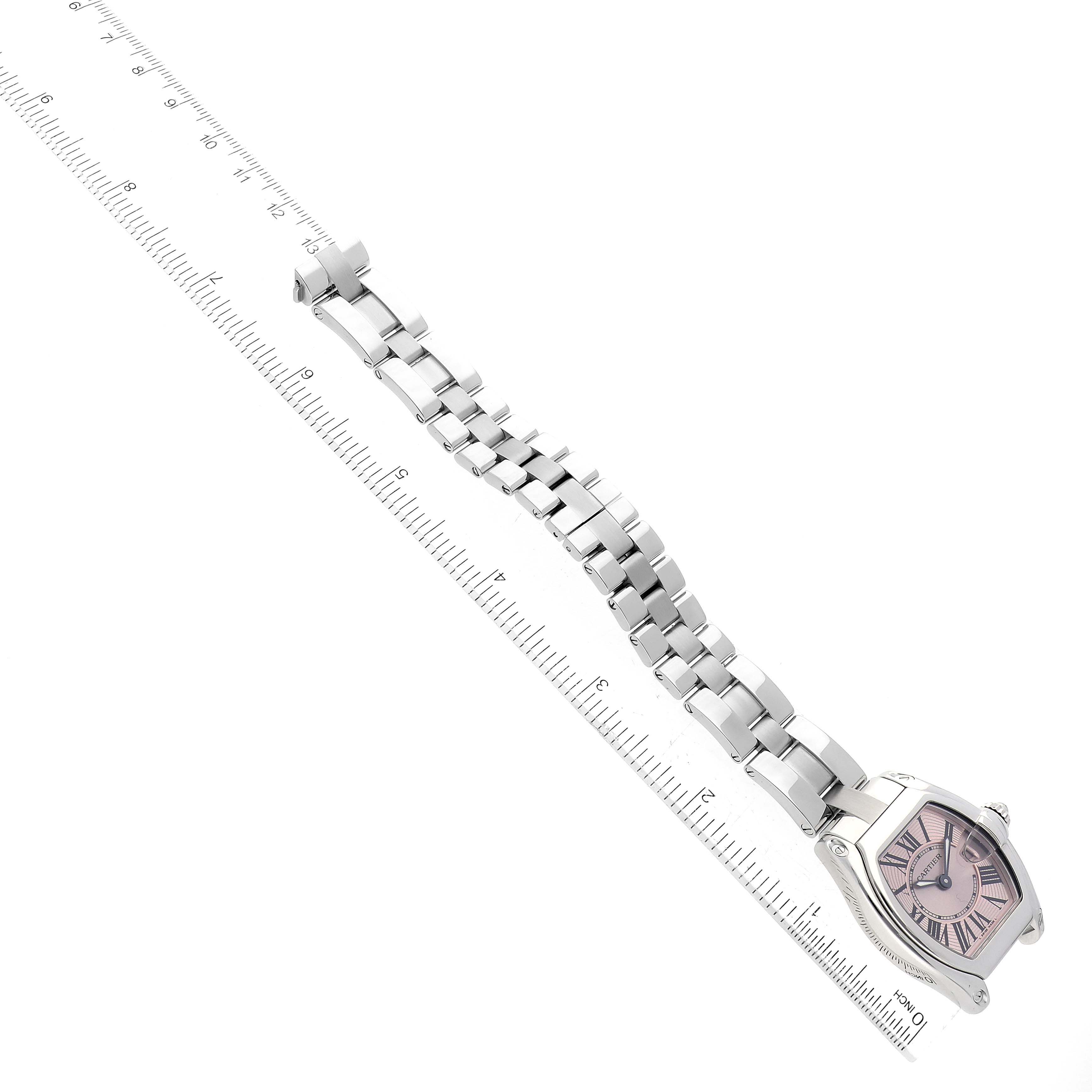 The image shows a Cartier Roadster W62017V3 Women's Stainless Steel Pink Dial W62017V3 Women's Stainless Steel Pink Dial watch, displaying part of the bracelet and the face, placed next to a ruler for measurement.