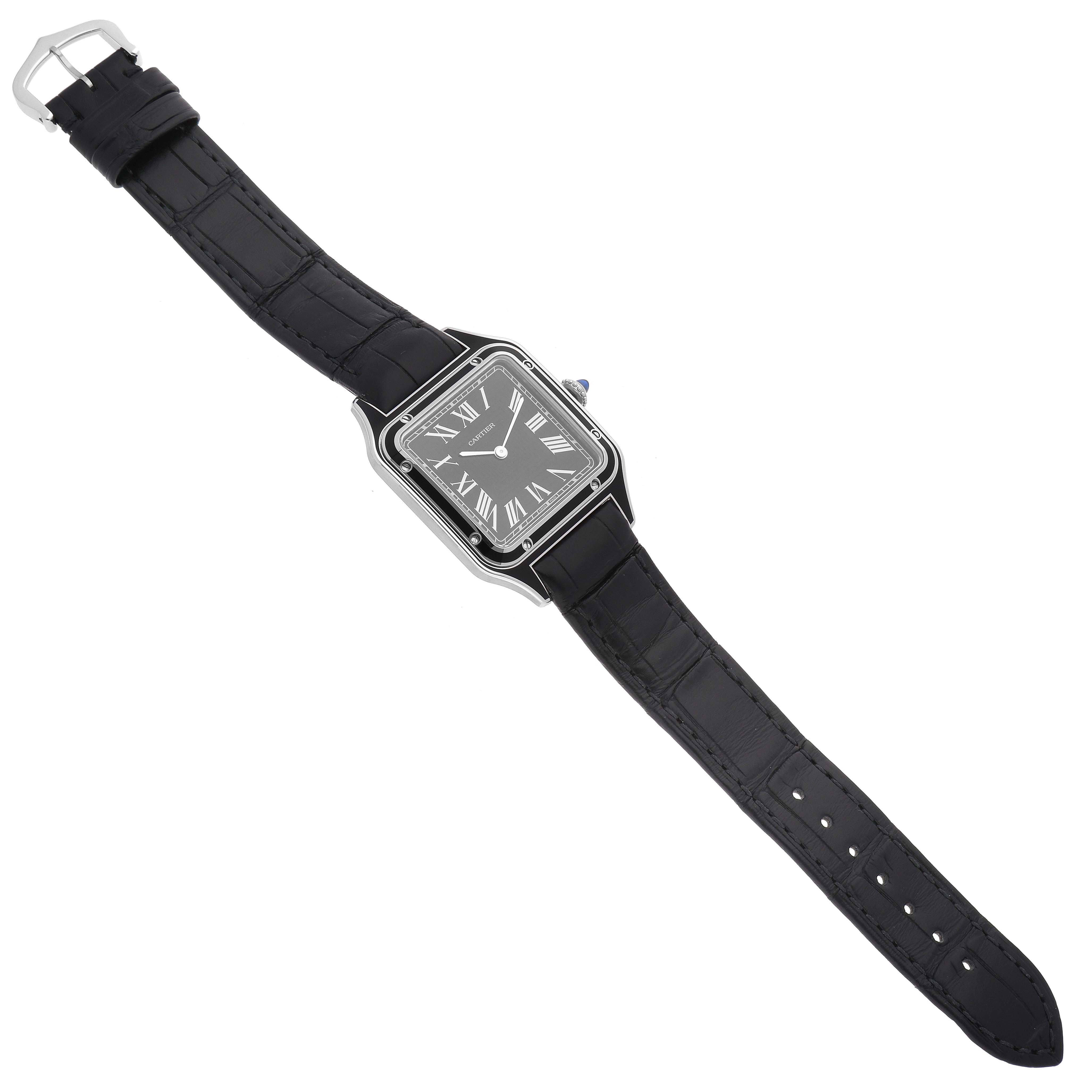 The image shows a Cartier Santos Dumont WSSA0046 Men's Stainless Steel Black Dial WSSA0046 Men's Stainless Steel Black Dial watch in full view from above, showcasing its face, black strap, and buckle.