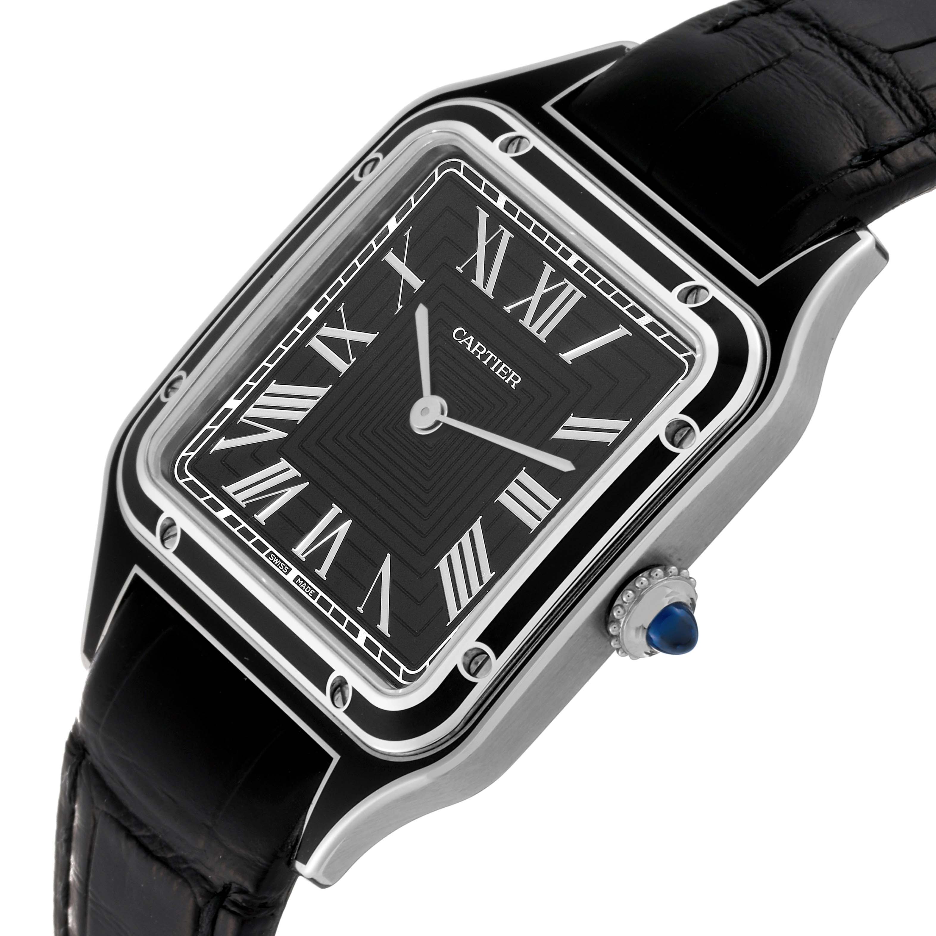 The image shows a Santos Dumont model by Cartier at an angle emphasizing its black dial, Roman numerals, and blue cabochon crown.
