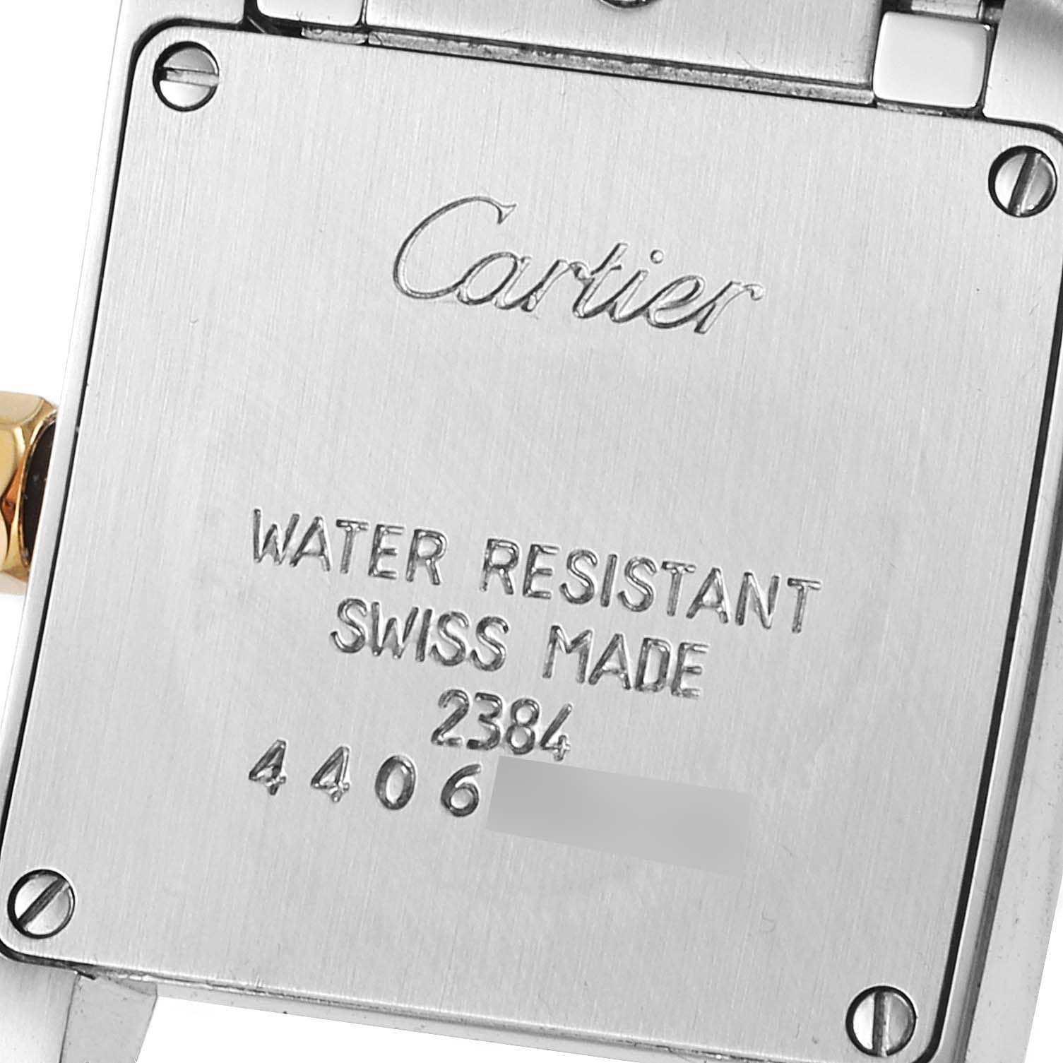 This image shows the back side of a Cartier Tank Francaise W51007Q4 Women's Steel and Gold (two tone) Silver Dial W51007Q4 Women's Steel and Gold (two tone) Silver Dial watch, highlighting the engraved details.