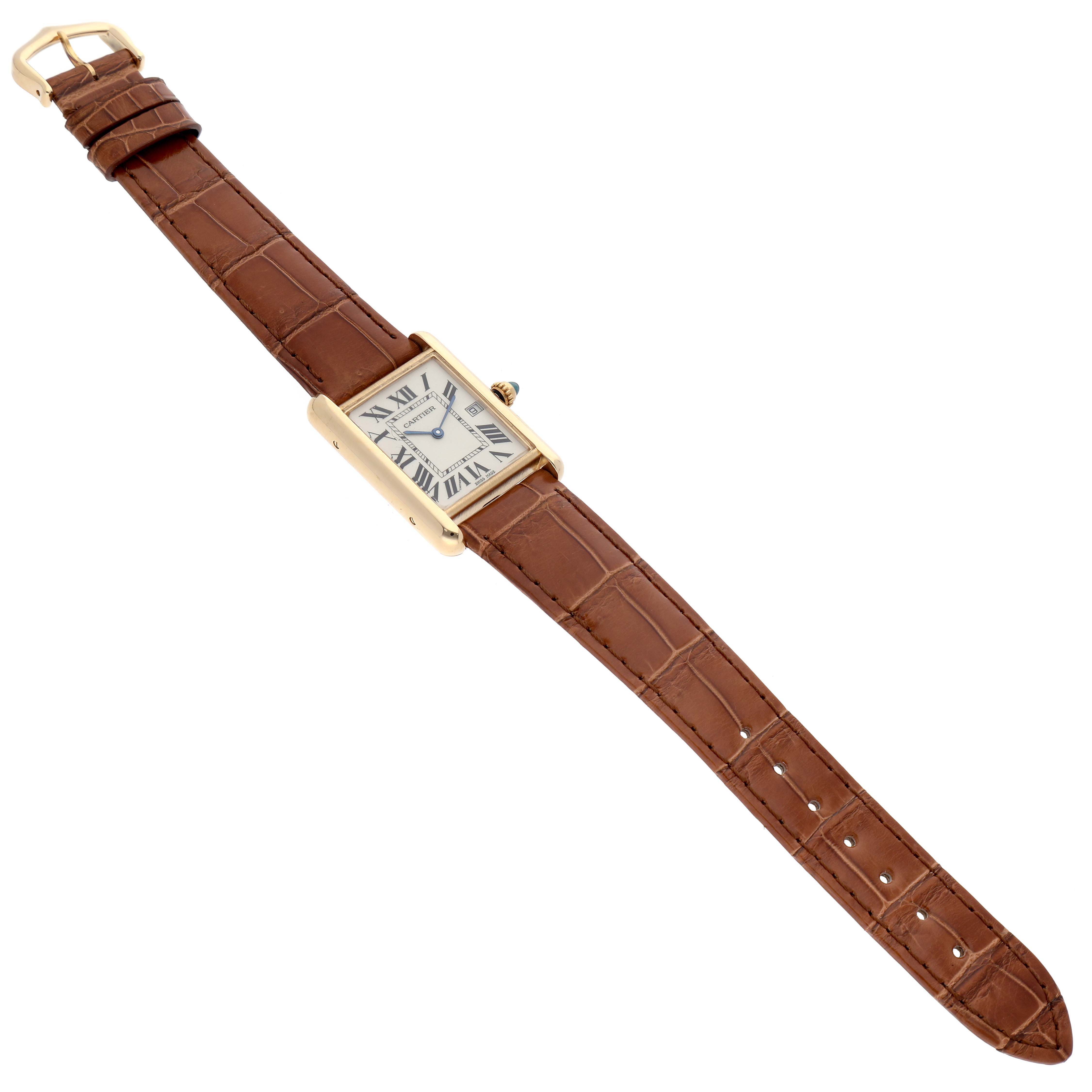 The Cartier Tank Louis W1529756 Men's Yellow Gold Silver Dial W1529756 Men's Yellow Gold Silver Dial watch is shown at an oblique angle, displaying the face, band, and buckle.