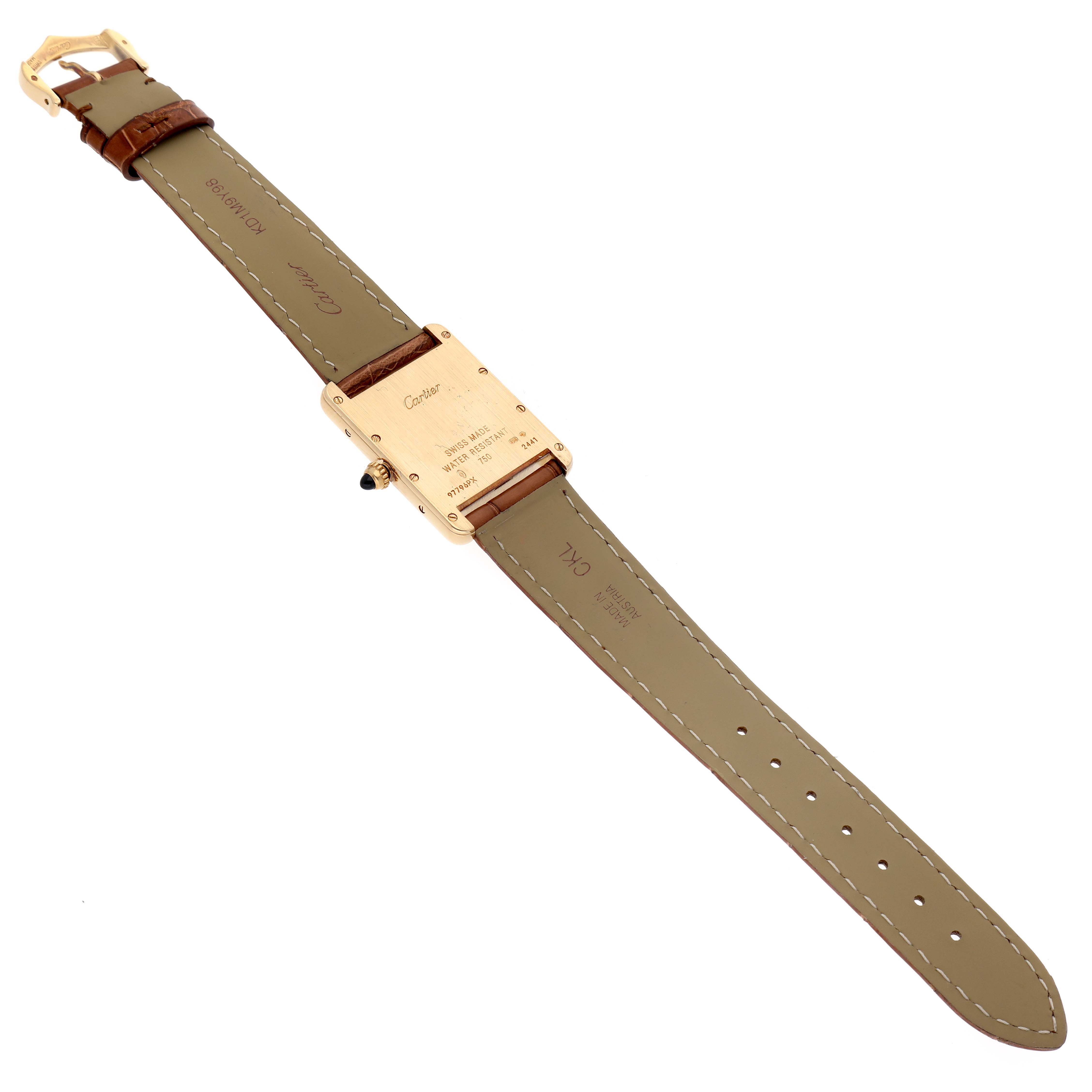 The image shows the back view of a Tank Louis by Cartier watch, showcasing the leather strap and caseback.