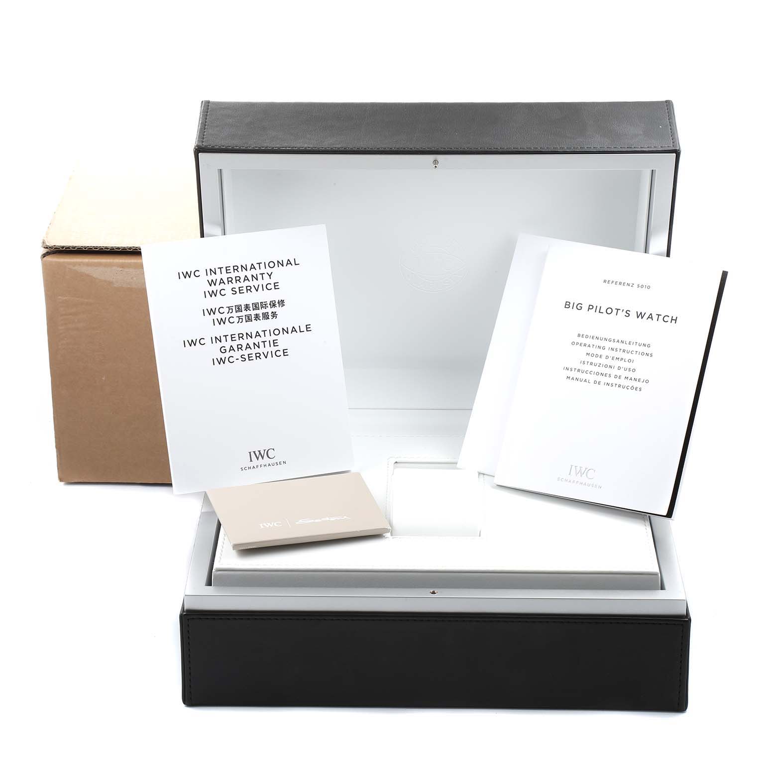 The image shows the packaging and documentation for an IWC Pilot IW500916 Men's Stainless Steel Blue Dial IW500916 Men's Stainless Steel Blue Dial watch, including a box, warranty card, and operating instructions.