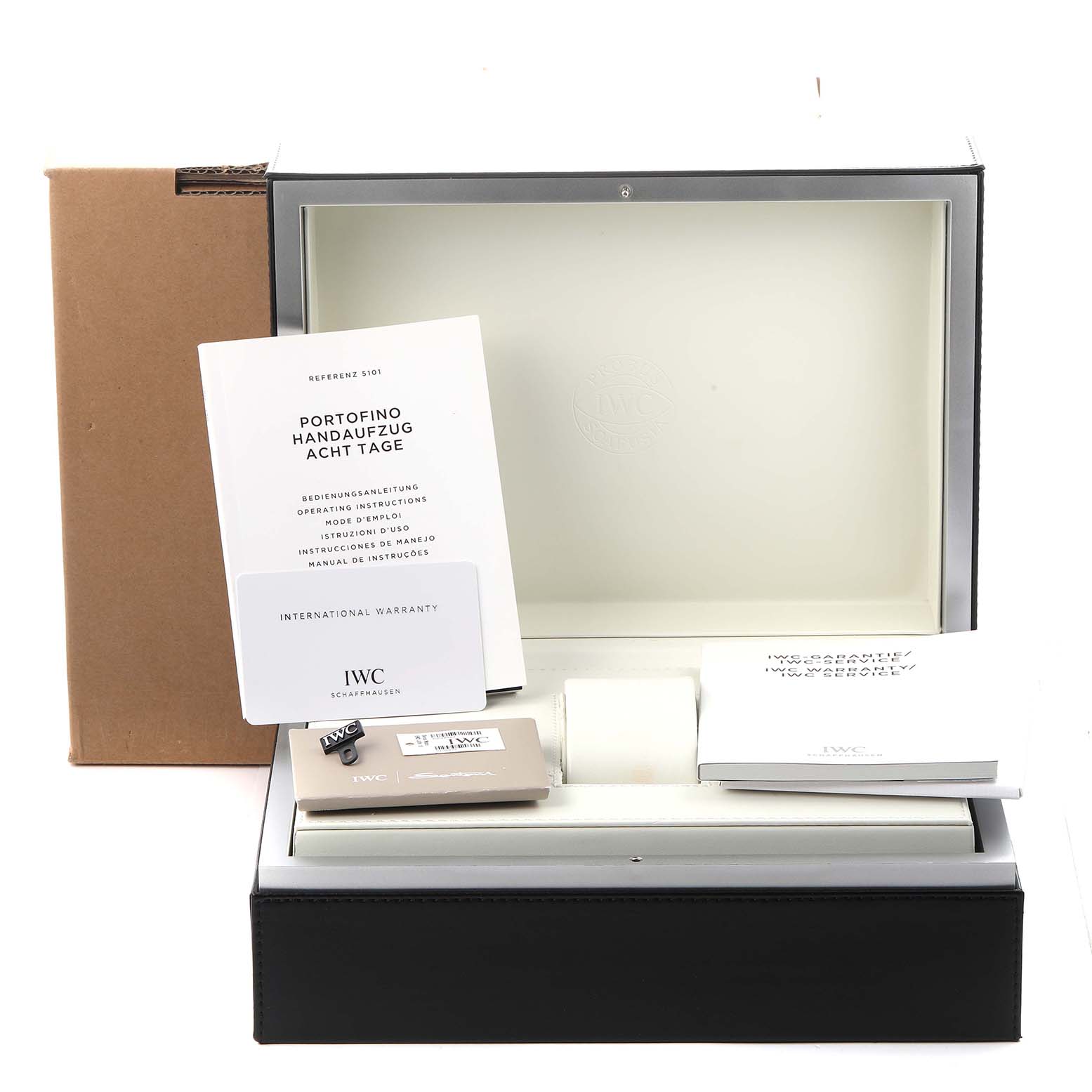 The image shows the packaging and accessories of the IWC Portofino IW510102 Men
s Stainless Steel Black Dial IW510102 Men
s Stainless Steel Black Dial watch, including manuals, tags, and a warranty card.