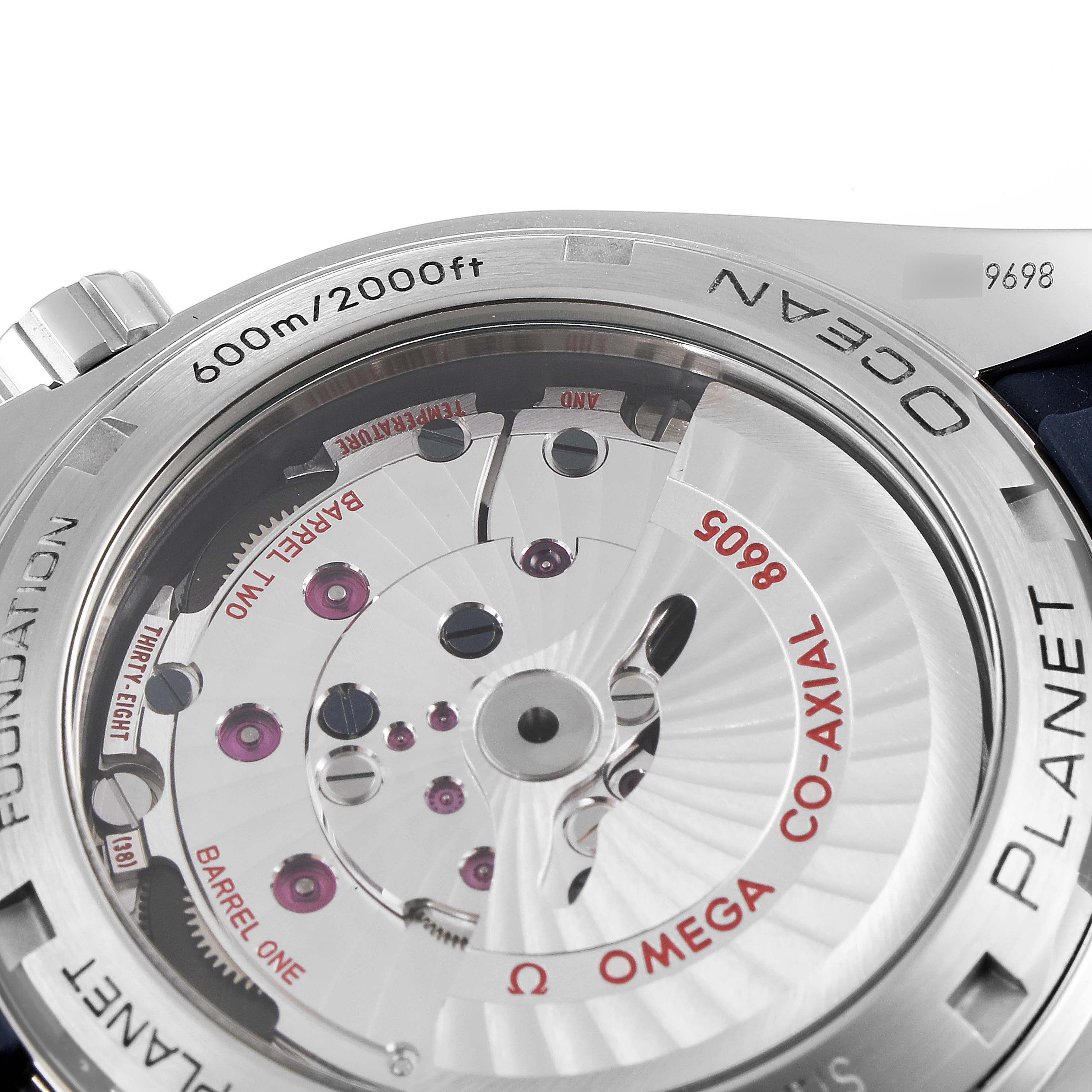 The image shows the back of the Omega Planet Ocean 232.30.44.22.03.001 Men
s Stainless Steel Blue Dial 232.30.44.22.03.001 Men
s Stainless Steel Blue Dial watch, highlighting its Co-Axial movement and water resistance of 600m/2000ft.