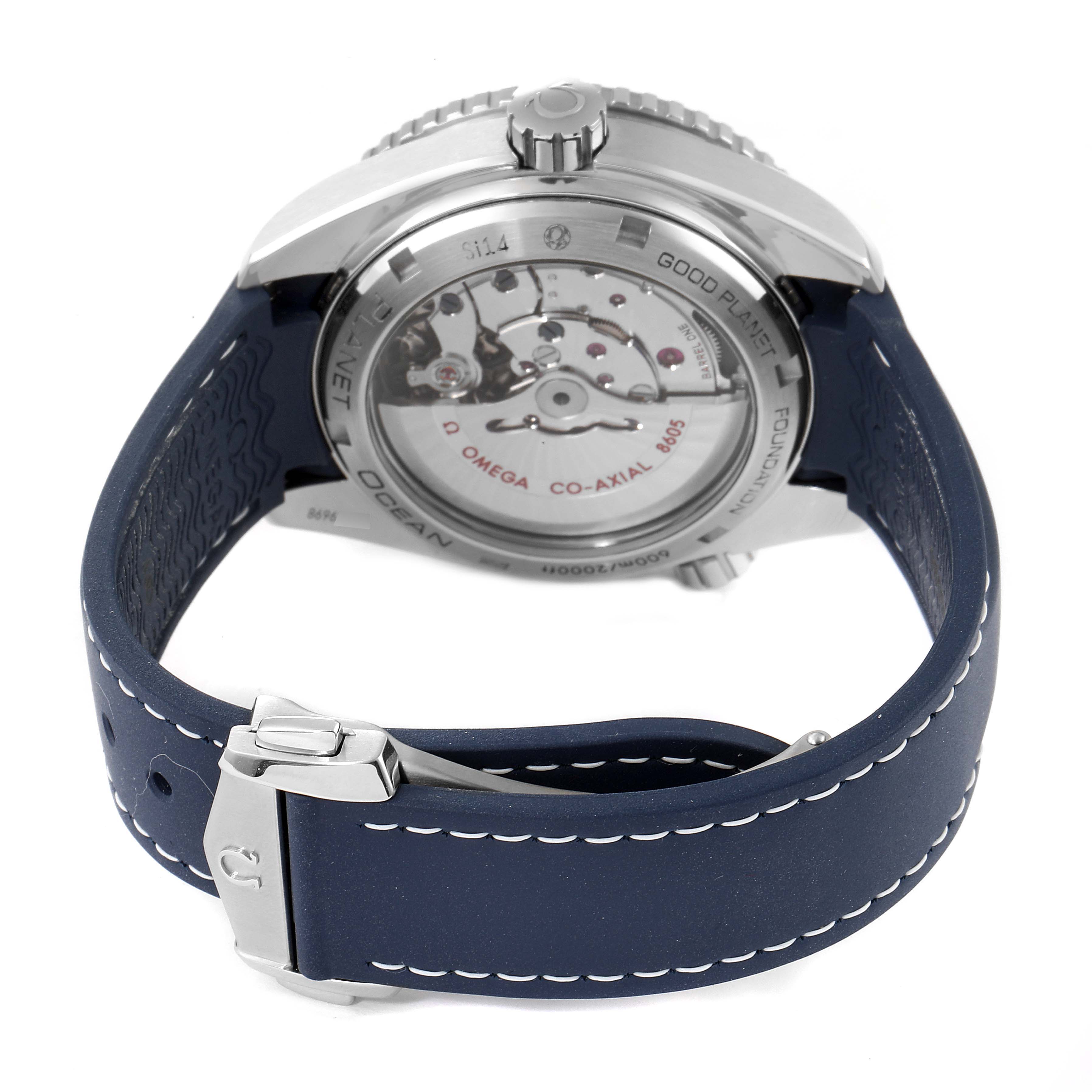 The image shows the back of the Omega Planet Ocean 232.30.44.22.03.001 Men
s Stainless Steel Blue Dial 232.30.44.22.03.001 Men
s Stainless Steel Blue Dial watch, highlighting the movement and blue strap with clasp.