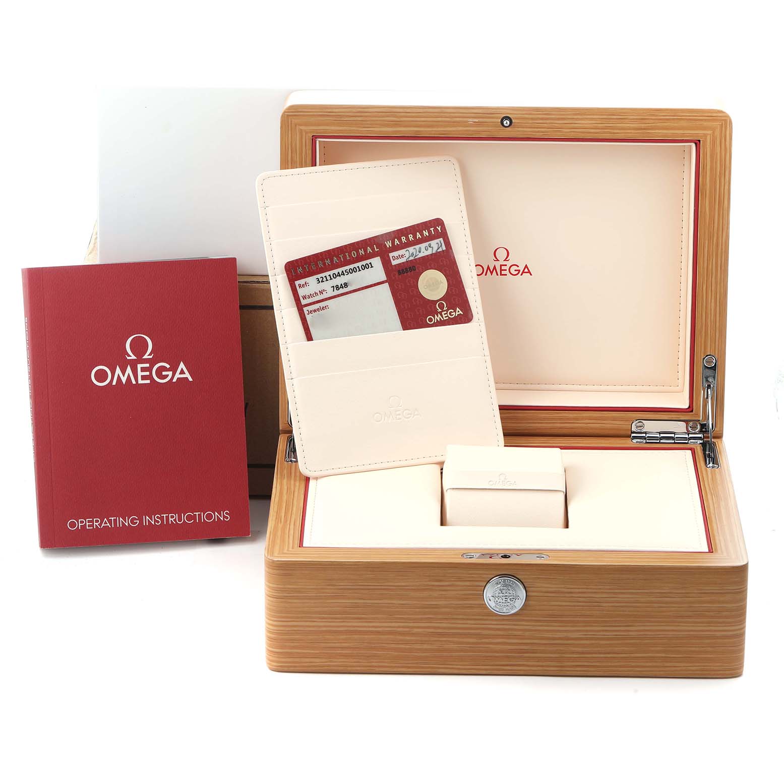 The Omega Speedmaster 321.10.44.50.01.001 Men's Stainless Steel Black Dial 321.10.44.50.01.001 Men's Stainless Steel Black Dial box is shown open with warranty cards and an instruction booklet on display.