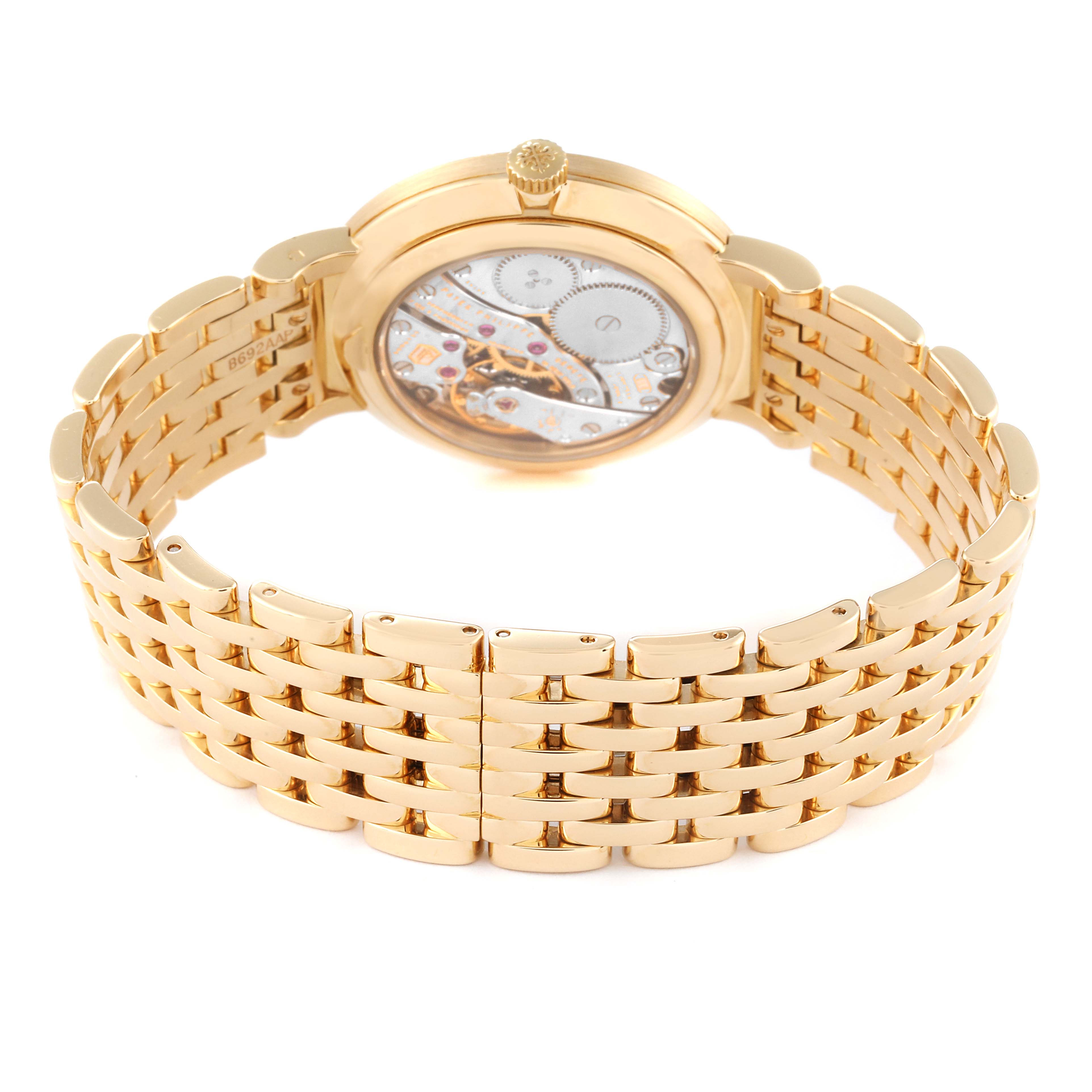 The image shows the back view of the Patek Philippe Calatrava 7119J Women's Yellow Gold White Dial 7119J Women's Yellow Gold White Dial watch, highlighting the intricate movement and gold bracelet.