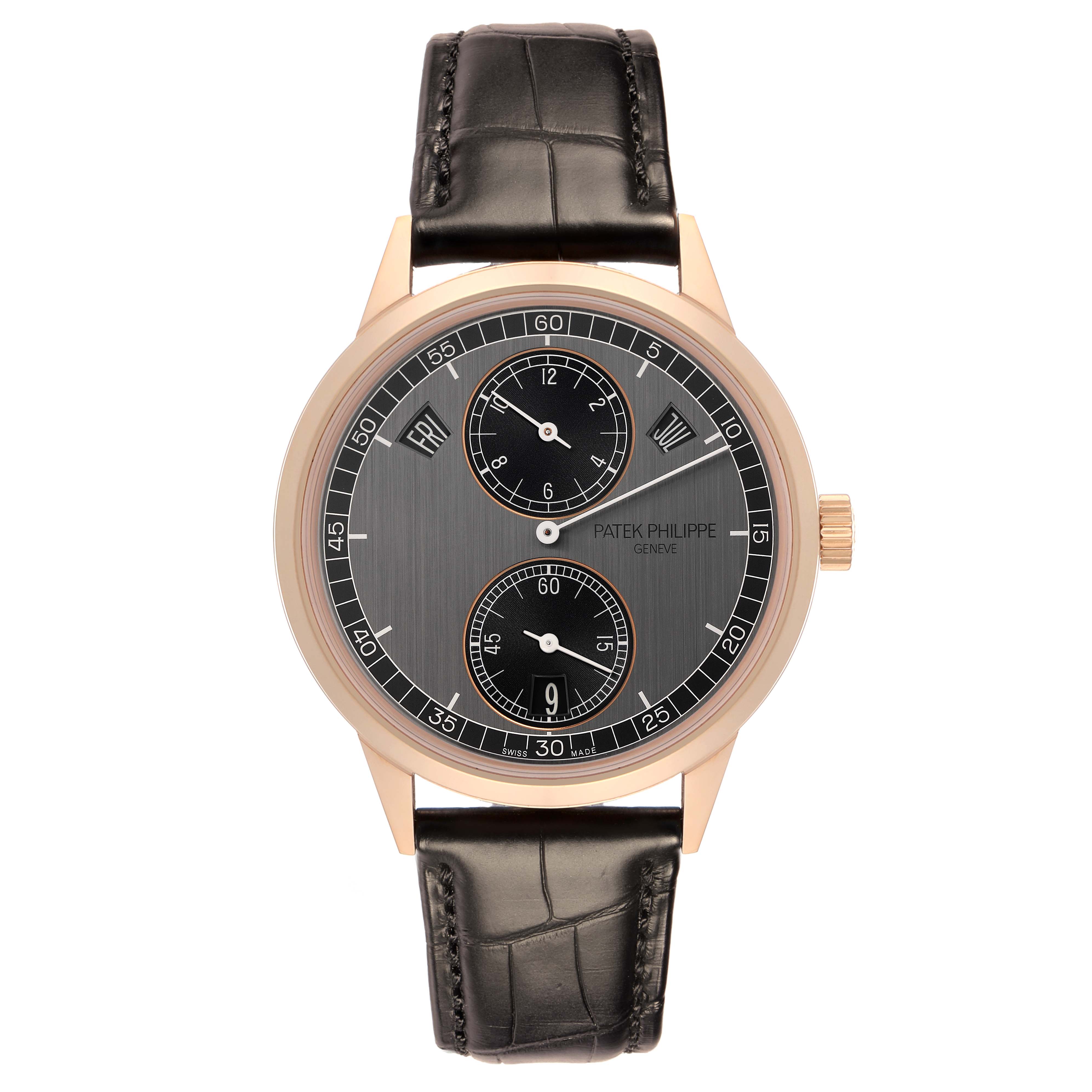 The Patek Philippe Complications 5235/50R-001 Men
s Rose Gold Black Dial 5235/50R-001 Men
s Rose Gold Black Dial watch is shown from a top-down angle, displaying its face, crown, and leather strap.