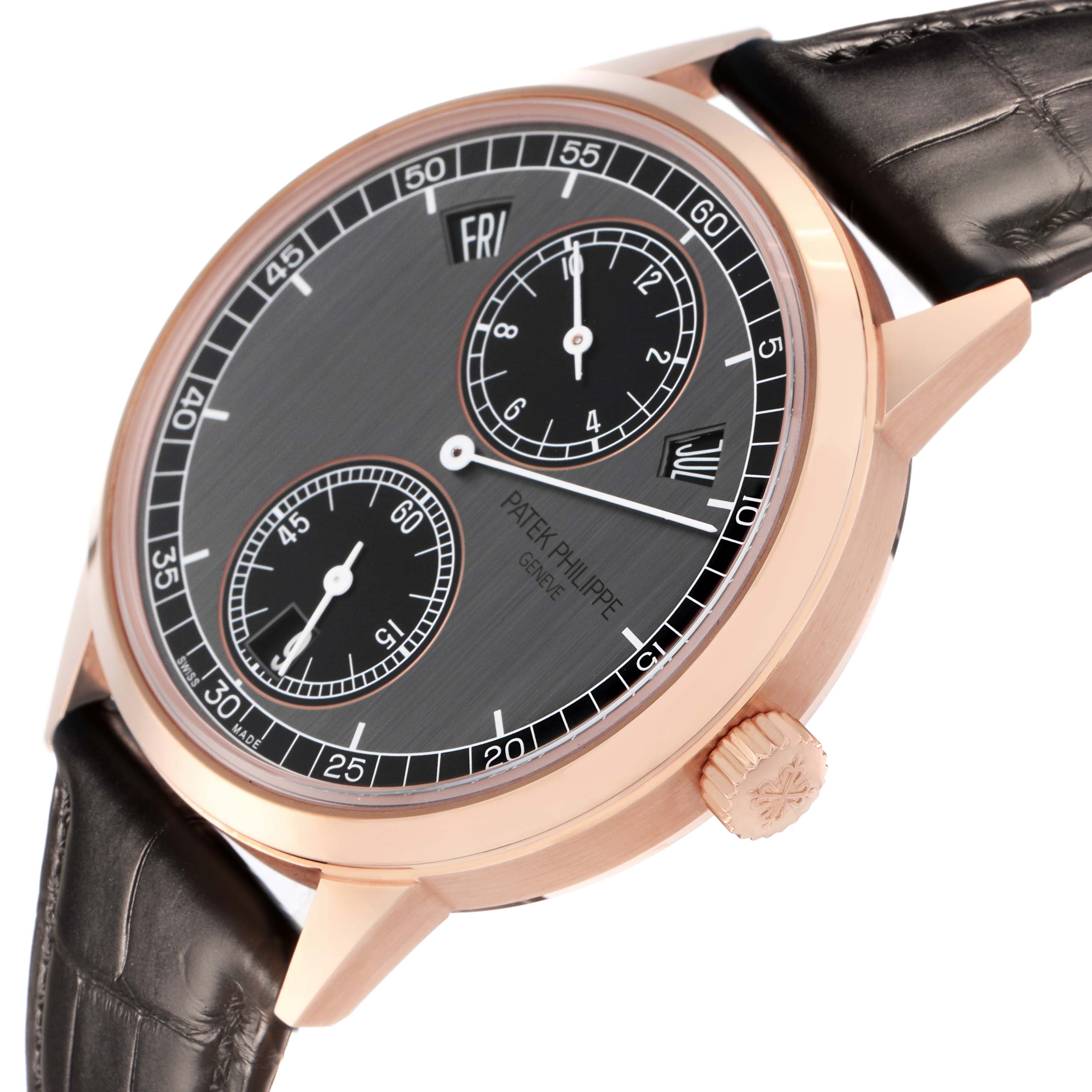 The Patek Philippe Complications 5235/50R-001 Men
s Rose Gold Black Dial 5235/50R-001 Men
s Rose Gold Black Dial watch is shown from a side angle, highlighting the dial, case, crown, and leather strap.