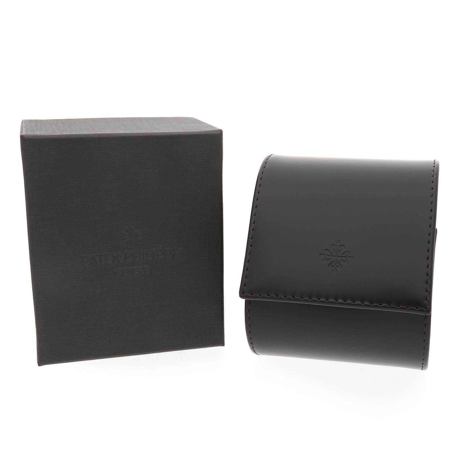 The image shows a Patek Philippe Twenty-4 4910/10A-011 Women's Stainless Steel Silver Dial watch box and a leather pouch, angled from the front.