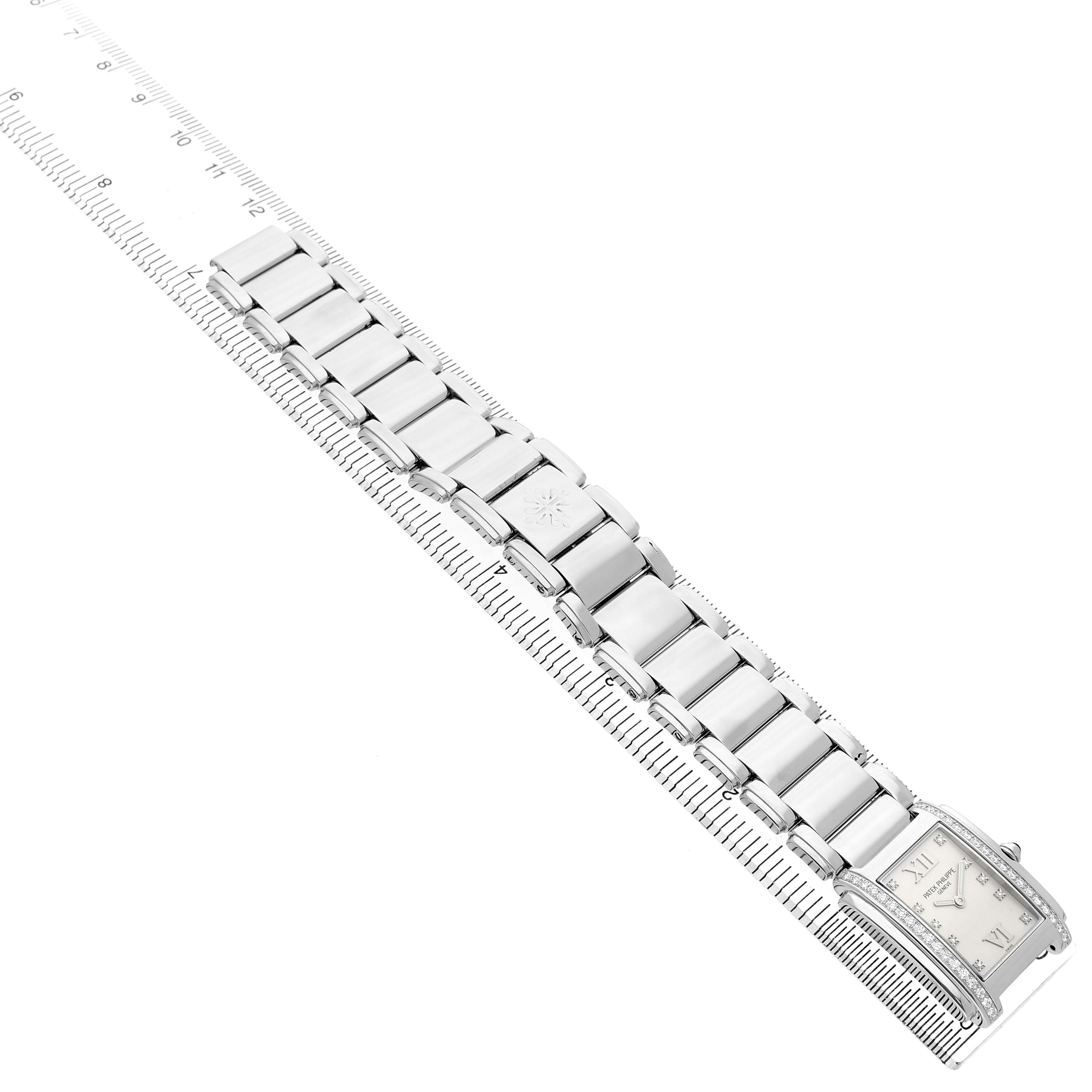 The image shows a Patek Philippe Twenty-4 4910/10A-011 Women's Stainless Steel Silver Dial watch from an angled top view, highlighting its bracelet and face with a ruler for scale.