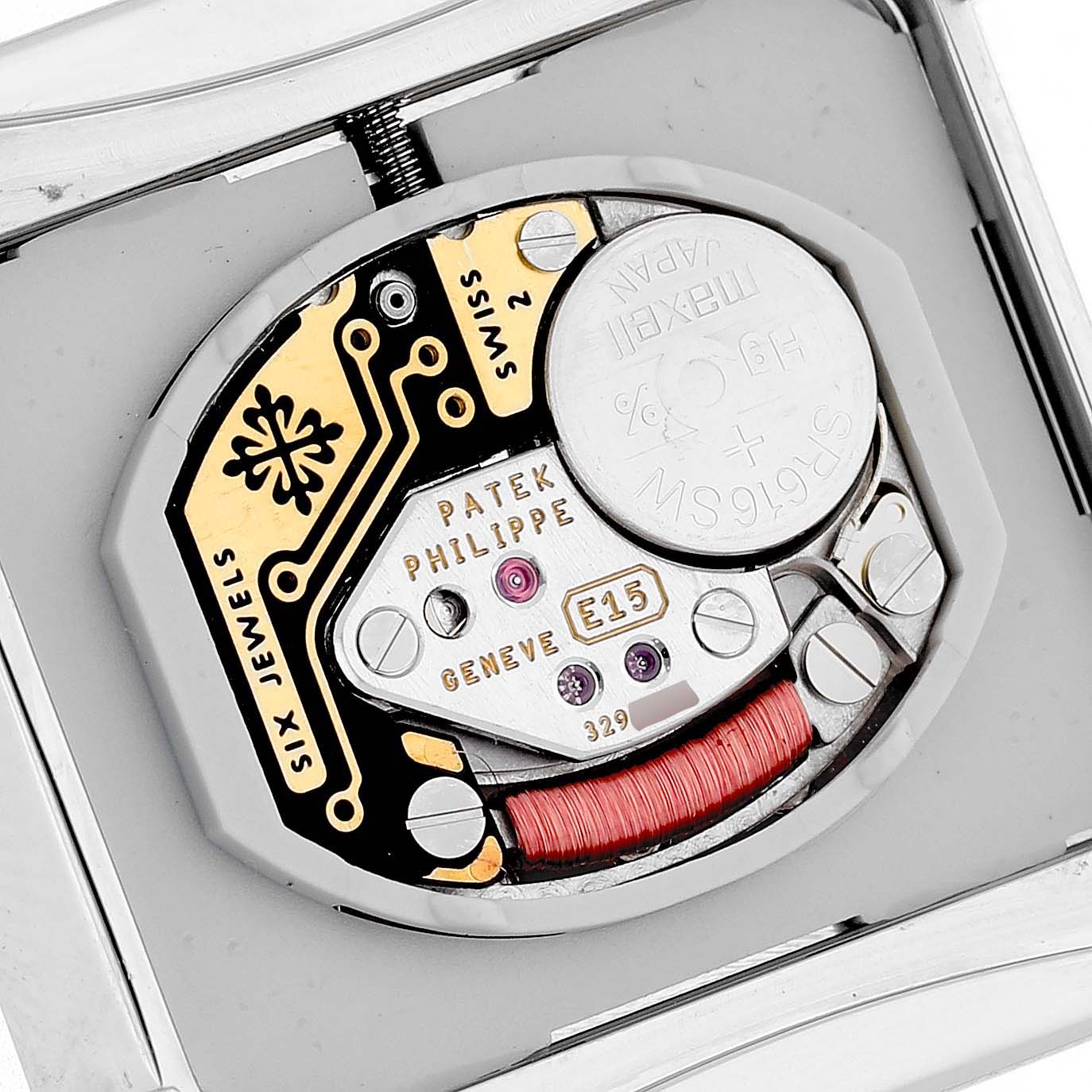 The image shows the back view of a Patek Philippe Twenty-4 4910/10A-011 Women's Stainless Steel Silver Dial watch, highlighting its movement and internal components.