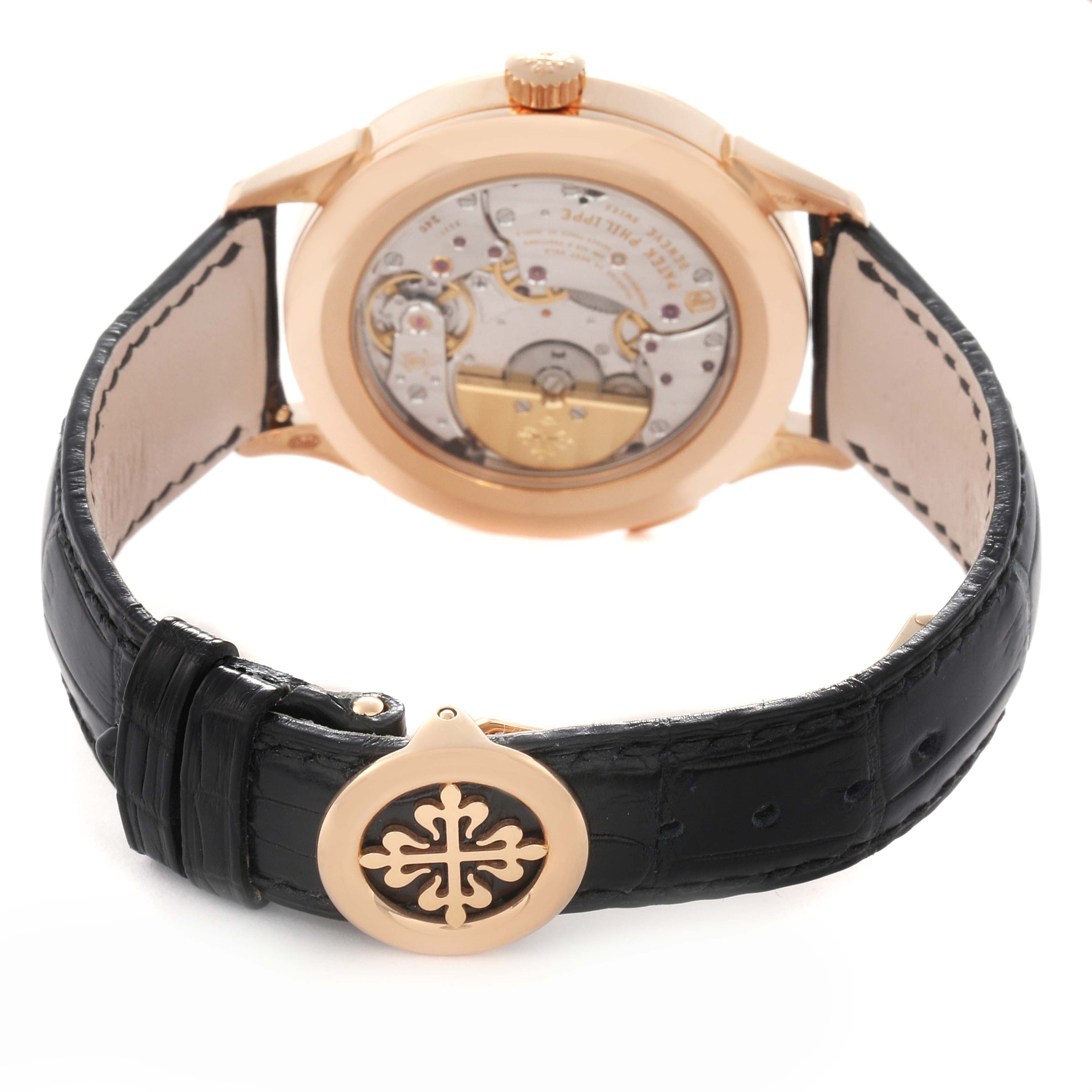 The Patek Philippe Complications 5230R-001 Men
s Rose Gold Grey Dial 5230R-001 Men
s Rose Gold Grey Dial watch is shown from the back, displaying the movement and the black leather strap with clasp.