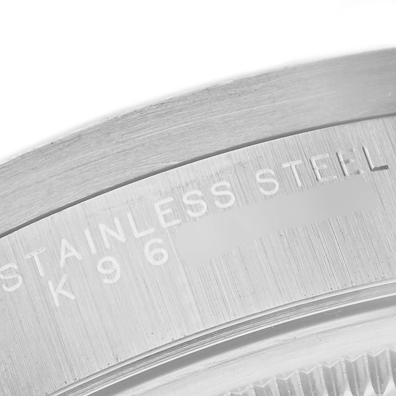 The image shows a close-up of the stainless steel casing of a Rolex Air-King 14010M Men's Stainless Steel White Dial 14010M Men's Stainless Steel White Dial watch, focusing on the engraved text.