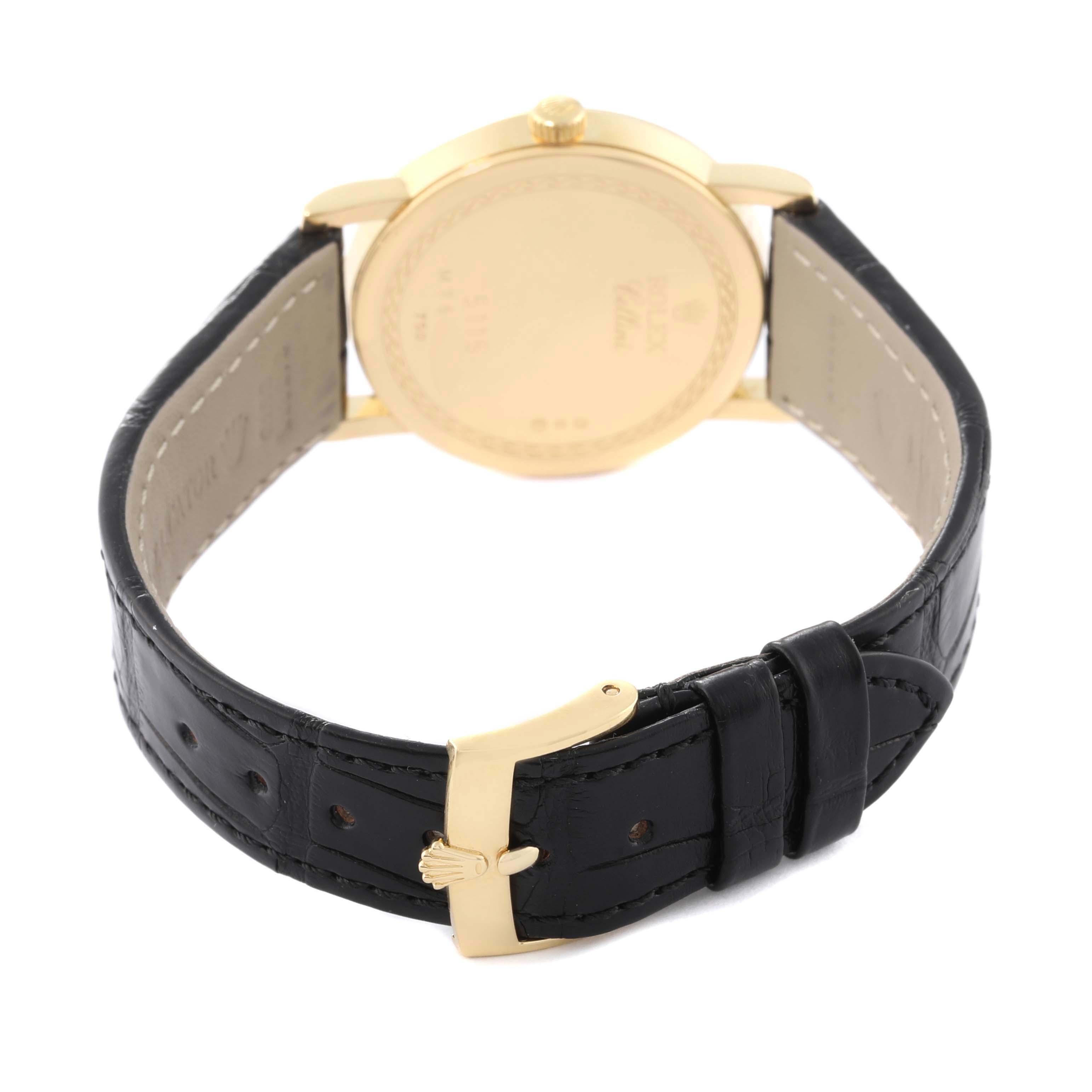 The image shows the back view of the Rolex Cellini 5115 Men's Yellow Gold Black Dial 5115 Men's Yellow Gold Black Dial watch, highlighting its clasp, strap, and case back.