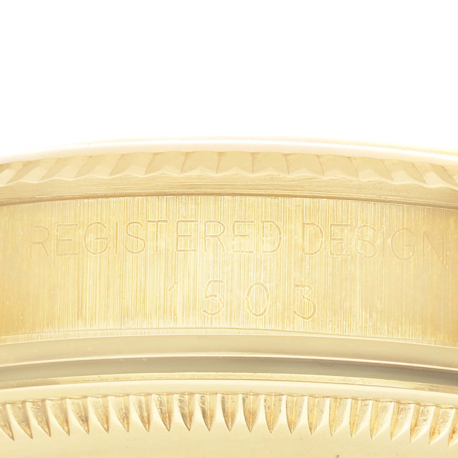 The image shows a close-up of the case side of a Rolex Vintage Collection 1503 Men's Yellow Gold Champagne Dial 1503 Men's Yellow Gold Champagne Dial model, highlighting the engraved design markings.