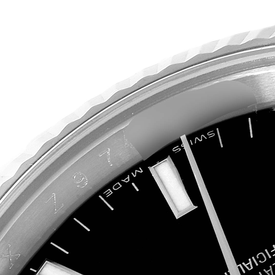 Close-up of the top left section of the Rolex Date 115234 Men's Stainless Steel Black Dial 115234 Men's Stainless Steel Black Dial watch, showing part of the bezel, dial, and hour markers.