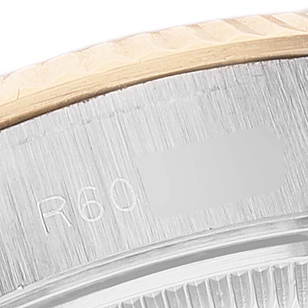 The image shows a close-up of the bezel and part of the case side of a Rolex Datejust 69173 Women
s Steel and Gold (two tone) Champagne Dial 69173 Women
s Steel and Gold (two tone) Champagne Dial watch.