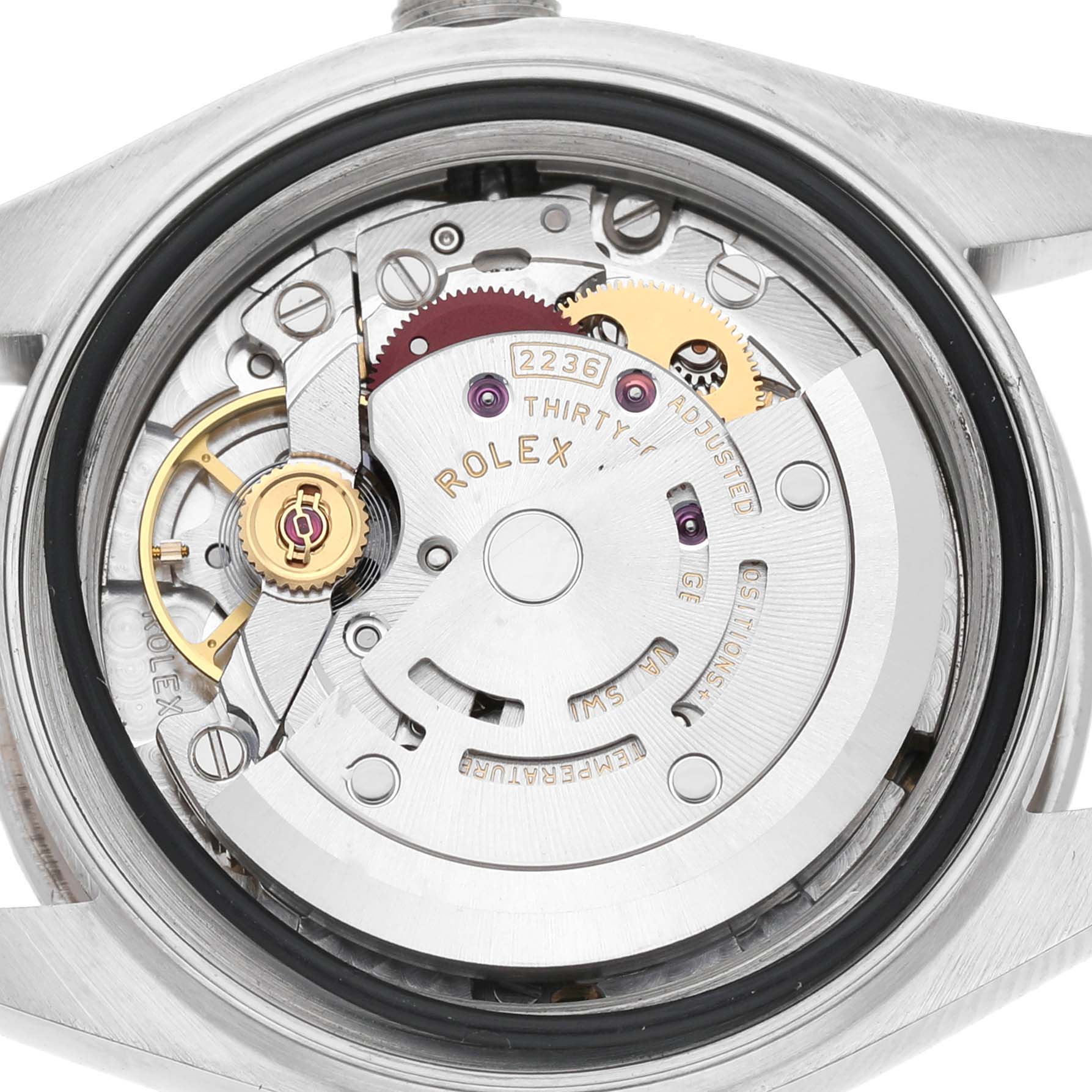 The image shows the movement of a Rolex Datejust 279384 Women's Stainless Steel White Dial watch viewed from the back, highlighting gears and inscriptions.