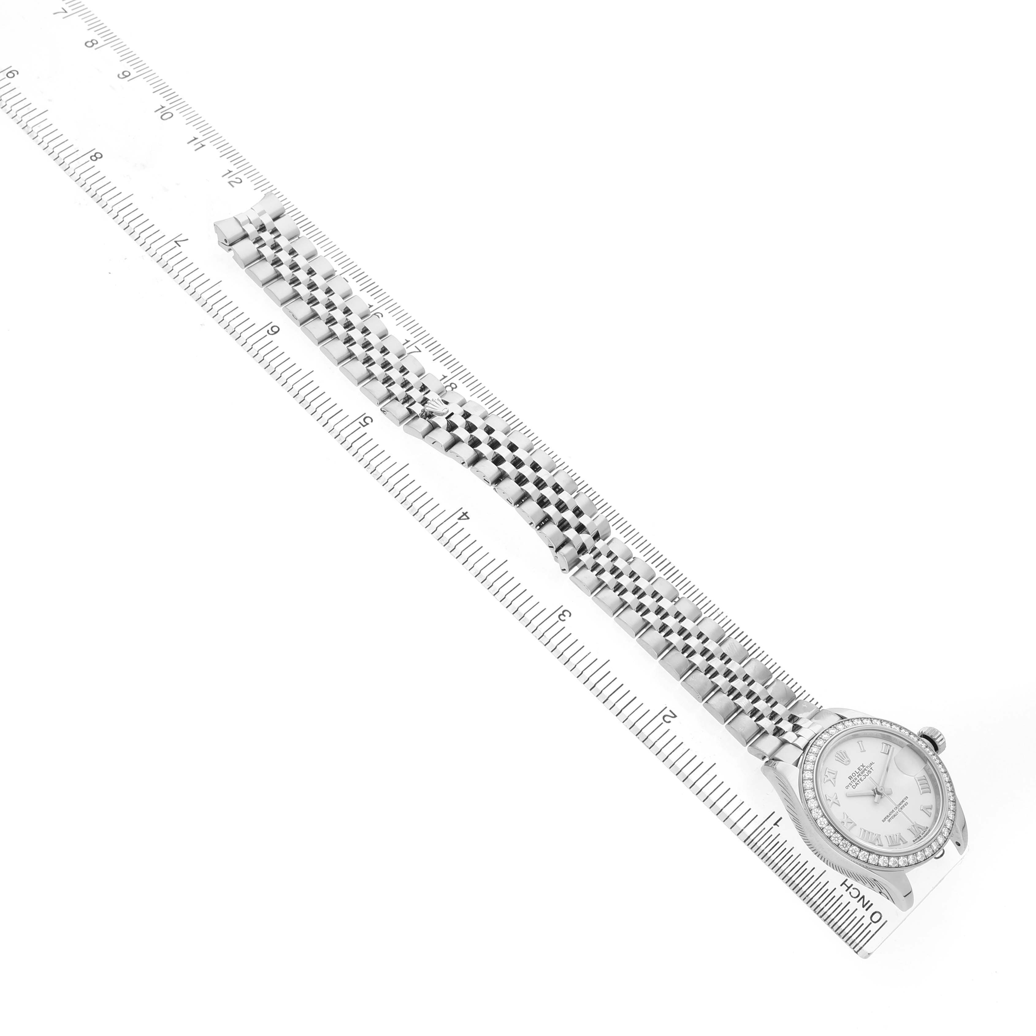 The image shows a Rolex Datejust 279384 Women's Stainless Steel White Dial watch laid flat alongside a ruler, displaying the bracelet and face from a top-down angle.