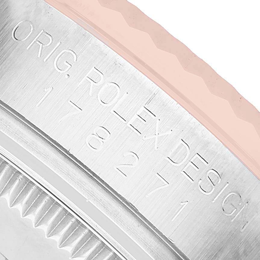 The image shows a close-up of the case edge with engravings on a Mid-Size Rolex watch.