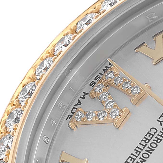The image shows a close-up of a Rolex Mid-Size 178383 Women's Steel and Gold (two tone) Silver Dial watch face, highlighting the diamond-encrusted bezel and partial Roman numerals.