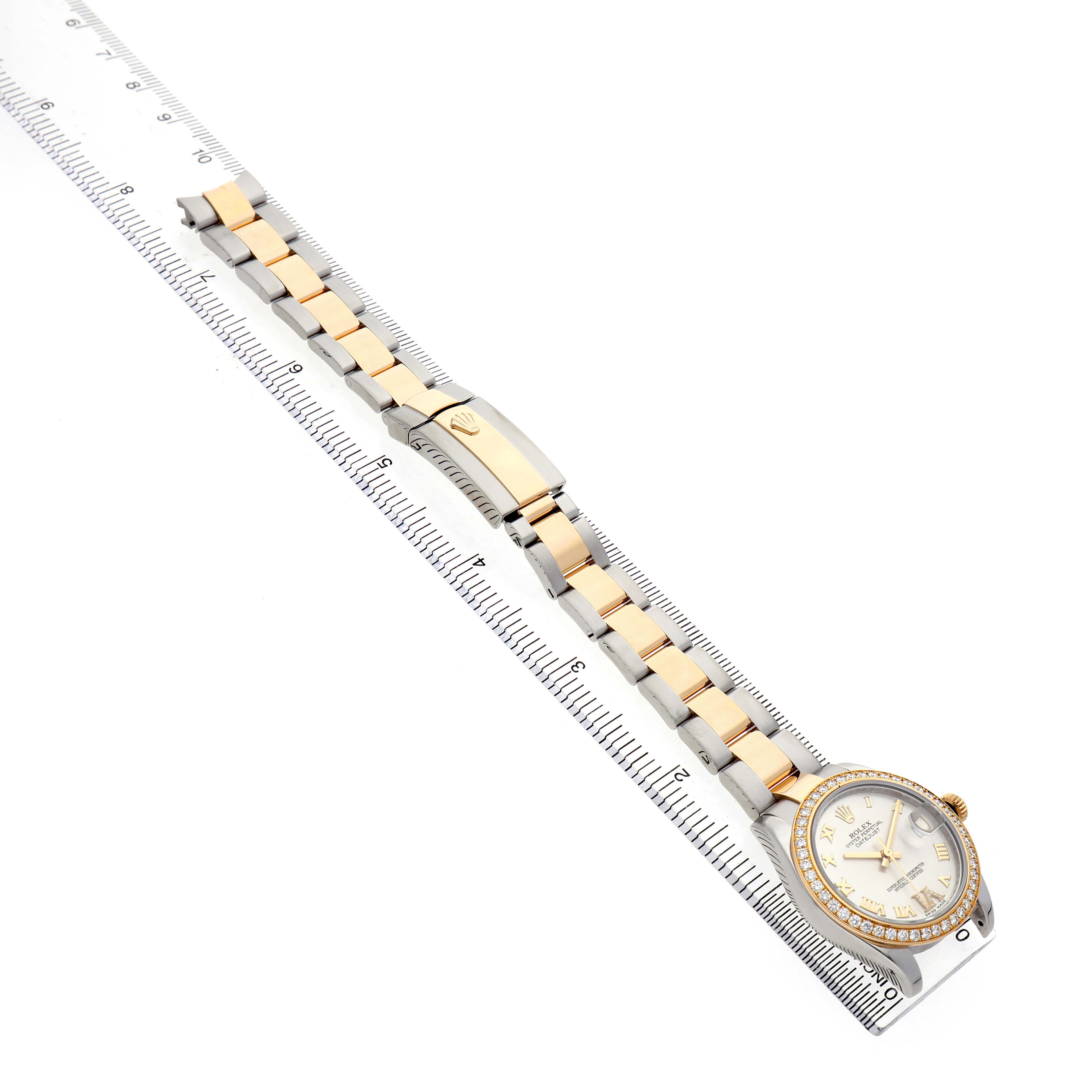 The Rolex Mid-Size 178383 Women's Steel and Gold (two tone) Silver Dial watch is shown from a top-down angle, displaying the bracelet, clasp, and face.