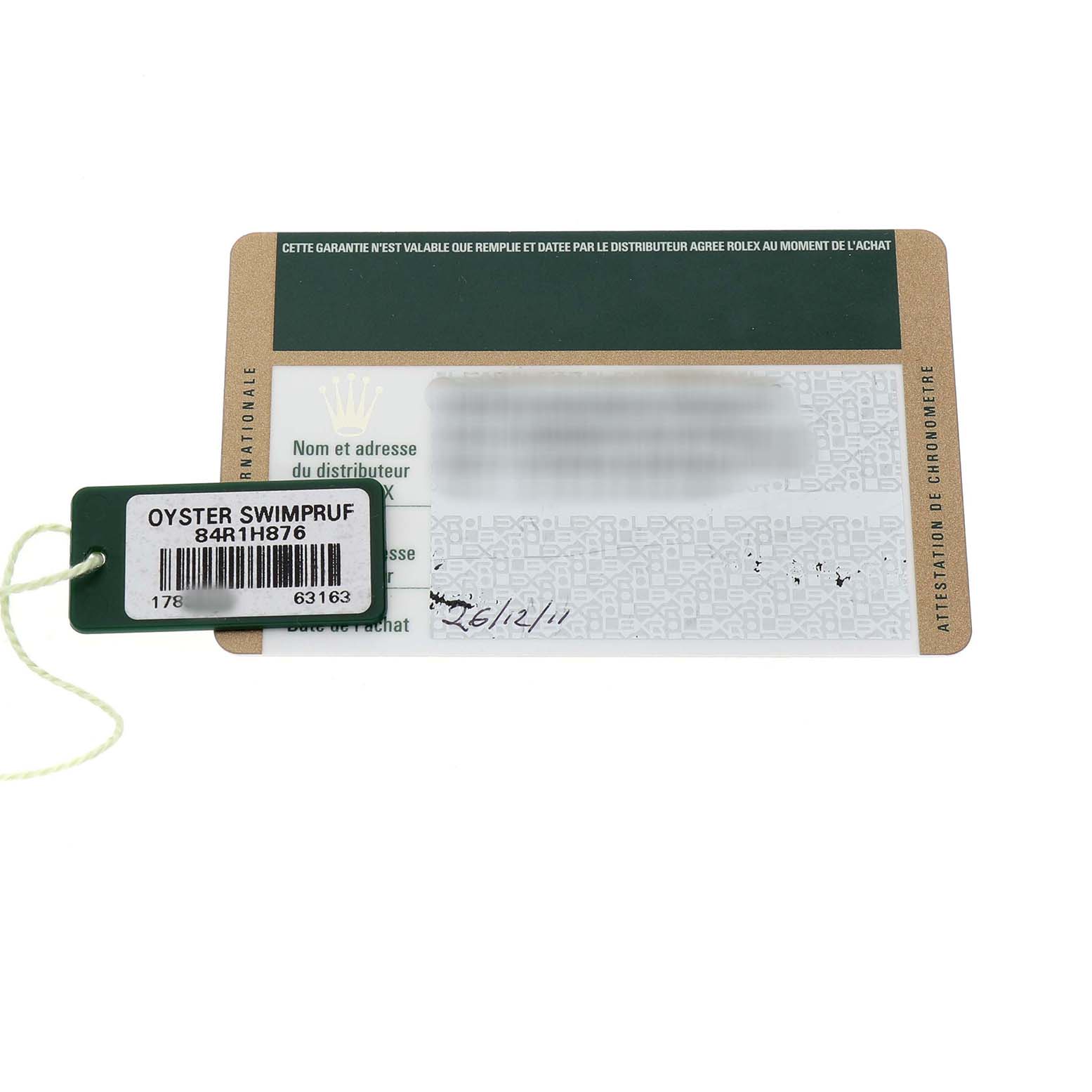 The image shows a Rolex warranty card and a green tag labeled "Oyster Swimpruf" for a Mid-Size model watch.